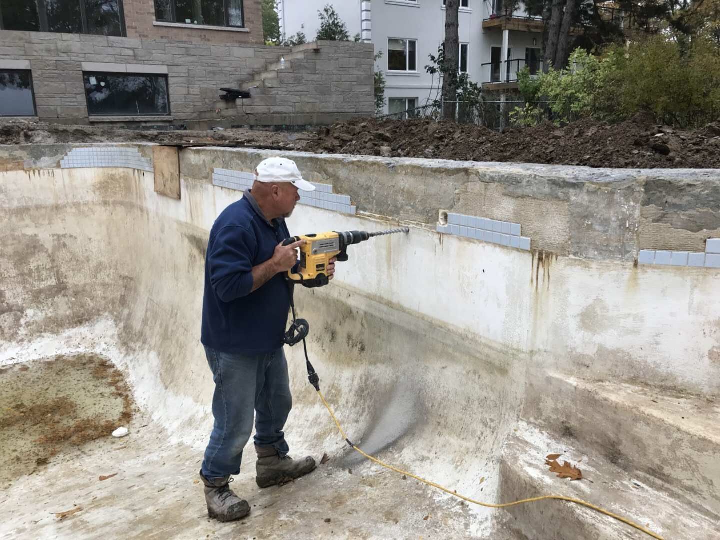 Swimming pool renovation in Toronto featuring structural repair and wall reinforcement preparation. This stage includes drilling, anchoring, and surface preparation to strengthen the pool shell and ensure long-term durability before resurfacing and final finishing by an experienced Toronto renovation contractor.