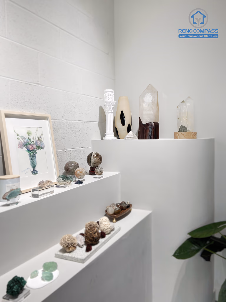 This image highlights a custom-built crystal display corner in a renovated crystal shop located in Markham. The design features clean white display niches, minimalist shelving, and focused lighting to enhance the visual impact of crystals and spiritual items. Neutral wall finishes and polished flooring create a calm, gallery-like retail atmosphere. As a Toronto renovation company, Reno Compass specializes in boutique retail renovations that balance aesthetics, functionality, and customer flow.