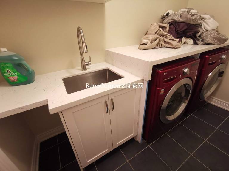 This Richmond Hill basement renovation includes a functional laundry room with custom cabinetry, quartz countertop, and integrated utility sink for everyday convenience. Designed and completed by a professional Toronto renovation company, the upgraded laundry area improves storage, organization, and usability within the finished basement. Durable flooring, modern fixtures, and efficient layout planning create a clean and practical space that enhances overall basement functionality and home value.