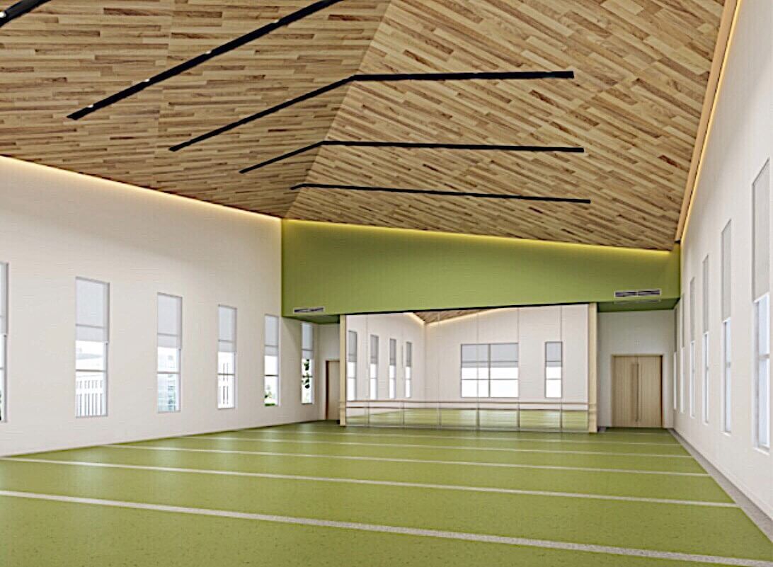 This Toronto daycare renovation features a spacious indoor activity hall designed for children’s physical development and group programs. The gym showcases a high wood-finish ceiling with modern linear lighting, soft green flooring for safety and comfort, and large windows that provide abundant natural light.

The open layout supports sports, movement classes, and indoor play while maintaining a clean, calming environment for young learners. This commercial daycare interior renovation in Toronto highlights functional design, safety-focused materials, and a contemporary aesthetic tailored for educational and recreational use.