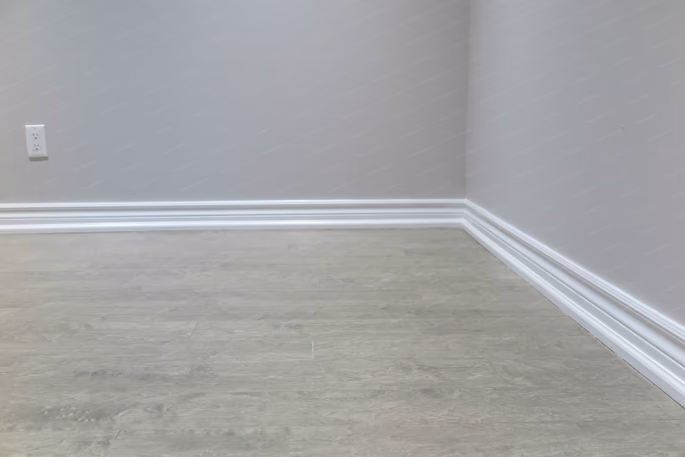 This Richmond Hill basement renovation highlights clean flooring installation and precisely finished baseboards, creating sharp lines and a refined, cohesive interior finish.