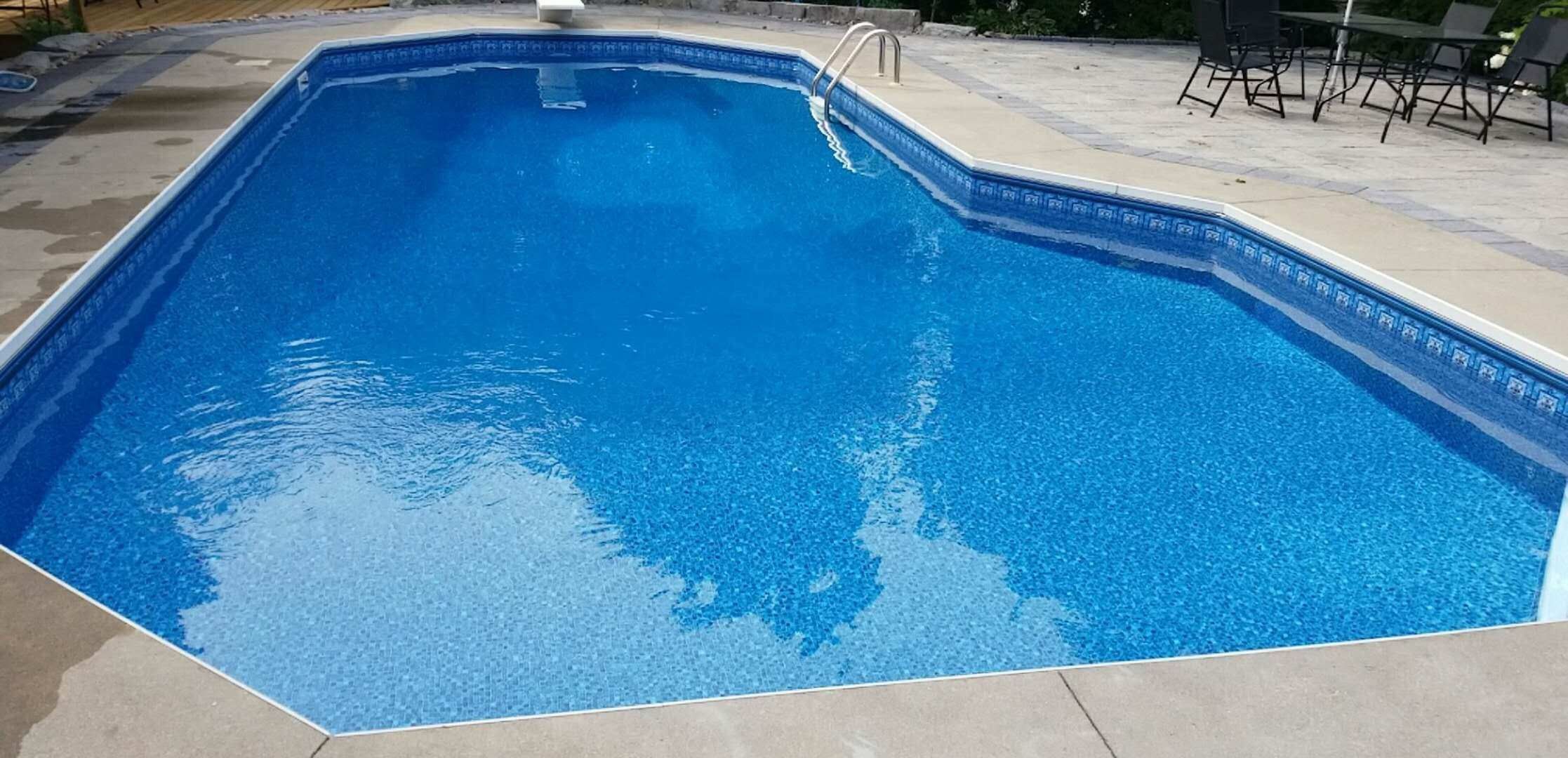 After renovation photo of a fully restored backyard swimming pool in Toronto. The new bright blue liner, clean water, and resurfaced edges highlight the professional pool transformation from old and damaged to modern and inviting. Expert pool renovation by local Toronto specialists.