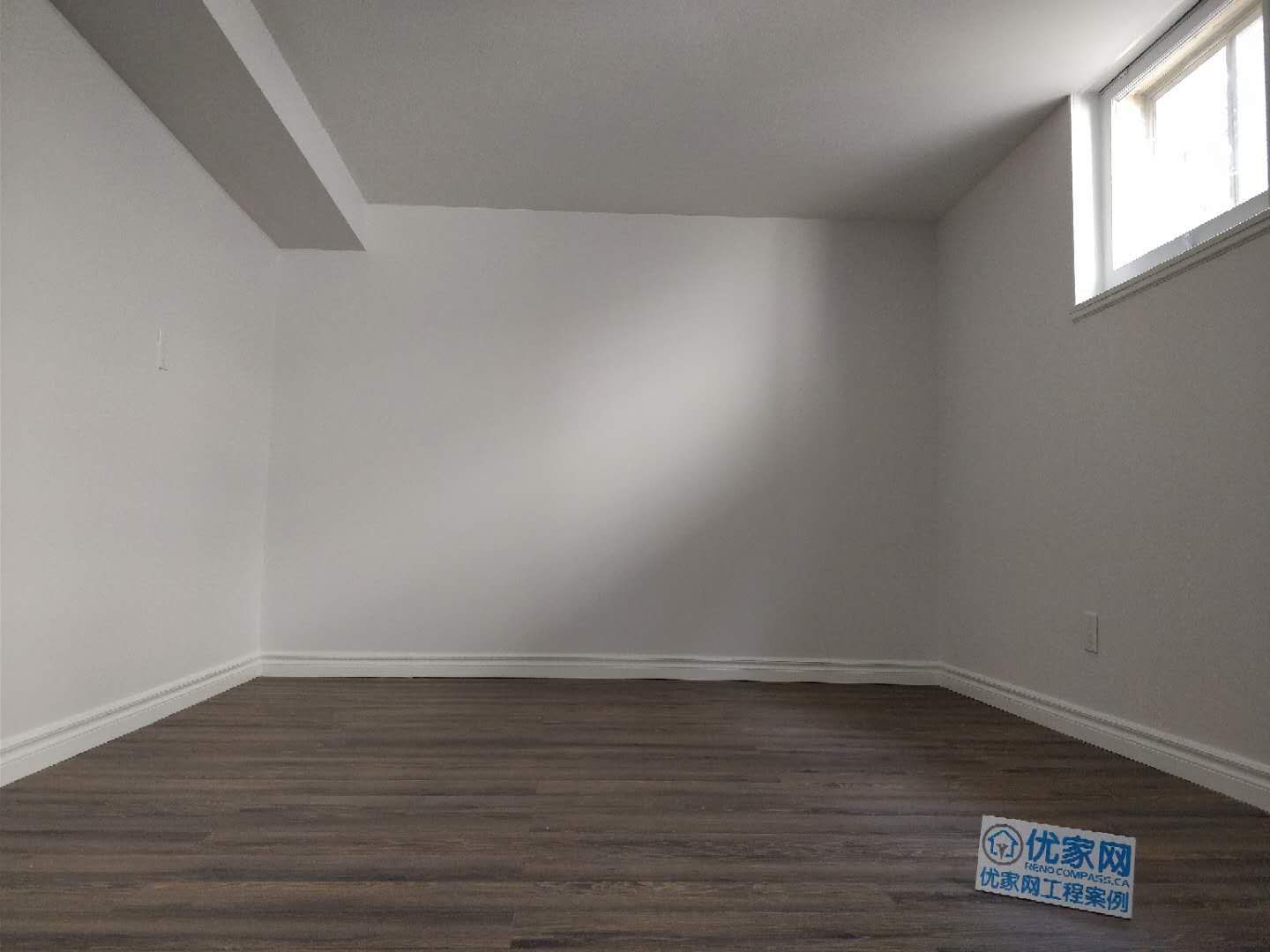 This Scarborough basement renovation features a clean and modern finished living space with durable vinyl flooring, smooth painted walls, and upgraded baseboards. A high basement window allows natural light to brighten the room, creating a comfortable and functional area suitable for a recreation room, home office, or additional living space. Completed with attention to detail, this basement upgrade improves both usability and property value for the homeowner.