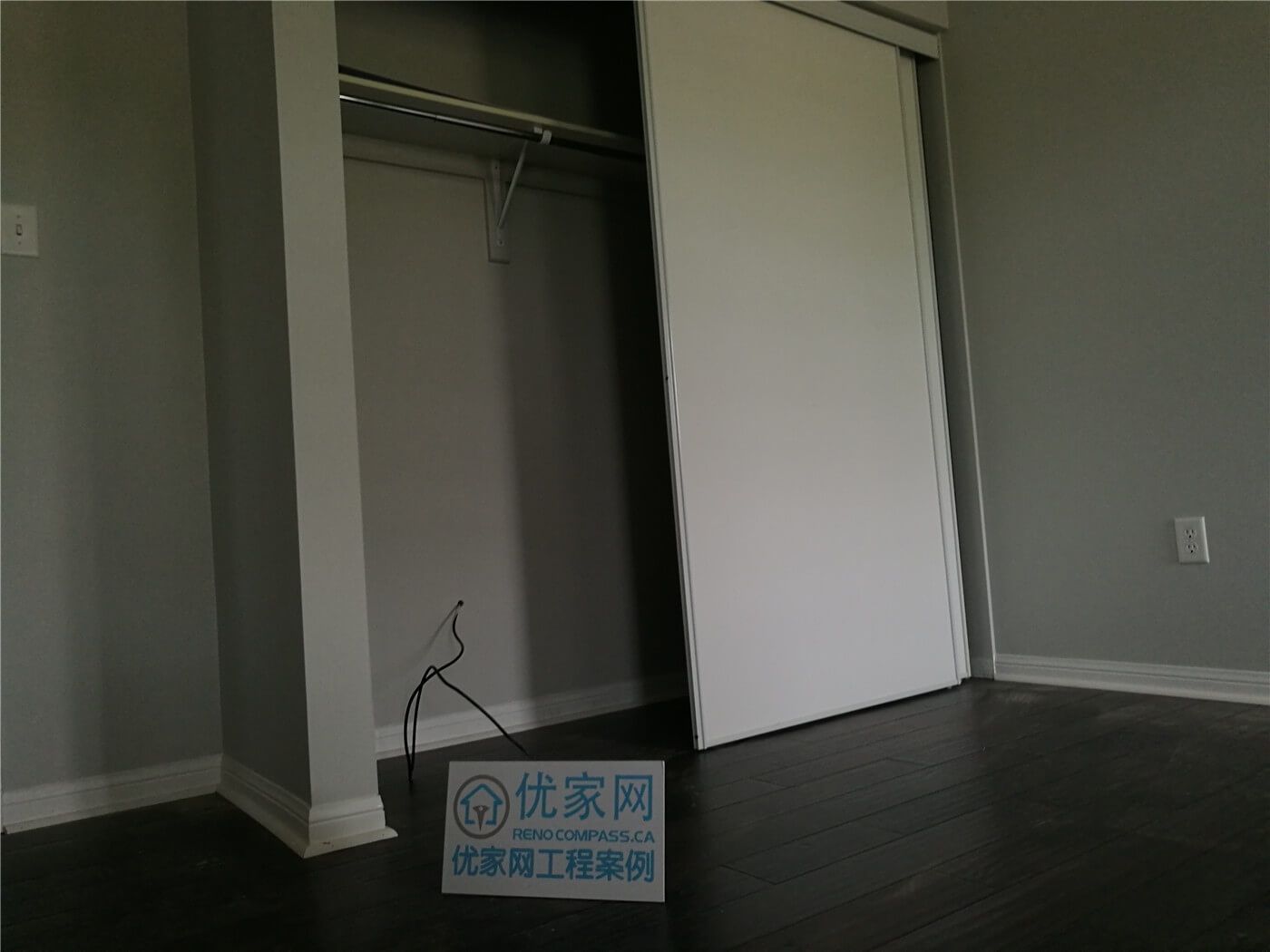 This image showcases the newly installed dark hardwood flooring extending seamlessly into the bedroom closet area in this Scarborough flooring replacement project. The clean transitions, precise baseboard finishing, and smooth plank alignment reflect professional craftsmanship. Completed by a trusted Toronto Renovation Company, the installation ensures durability, structural stability, and a polished modern look throughout the space.