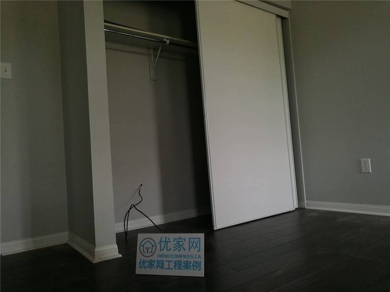 This image showcases the newly installed dark hardwood flooring extending seamlessly into the bedroom closet area in this Scarborough flooring replacement project. The clean transitions, precise baseboard finishing, and smooth plank alignment reflect professional craftsmanship. Completed by a trusted Toronto Renovation Company, the installation ensures durability, structural stability, and a polished modern look throughout the space.
