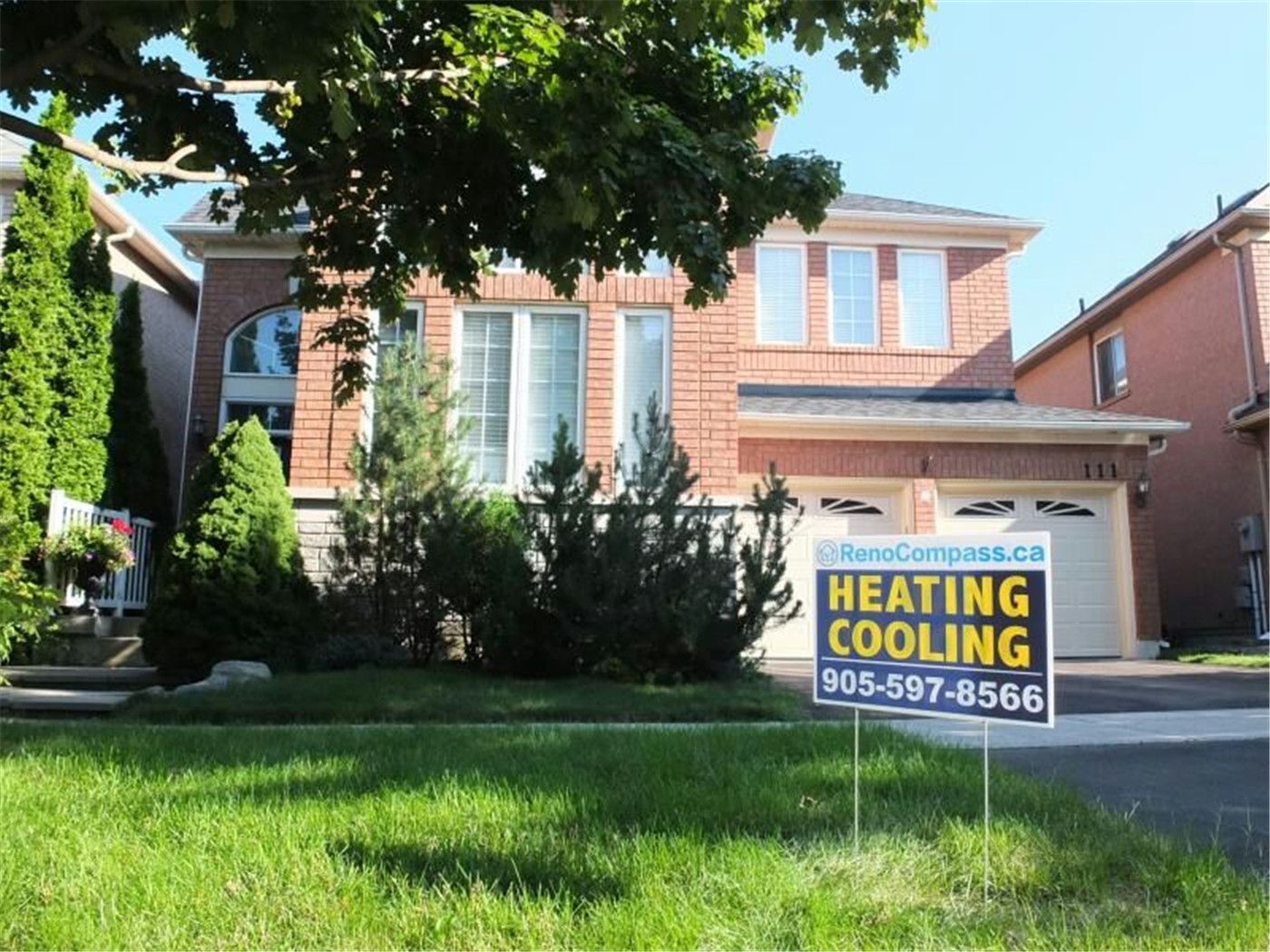 Professional outdoor air conditioner condenser installation by Reno Compass in Toronto. This energy-efficient HVAC unit is securely mounted on a raised stand with proper drainage and ventilation clearance, ensuring optimal cooling performance, durability, and safe operation for residential homes. Installed by licensed technicians for long-term reliability and comfort.