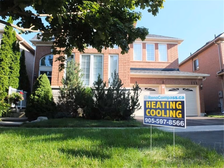 Professional outdoor air conditioner condenser installation by Reno Compass in Toronto. This energy-efficient HVAC unit is securely mounted on a raised stand with proper drainage and ventilation clearance, ensuring optimal cooling performance, durability, and safe operation for residential homes. Installed by licensed technicians for long-term reliability and comfort.