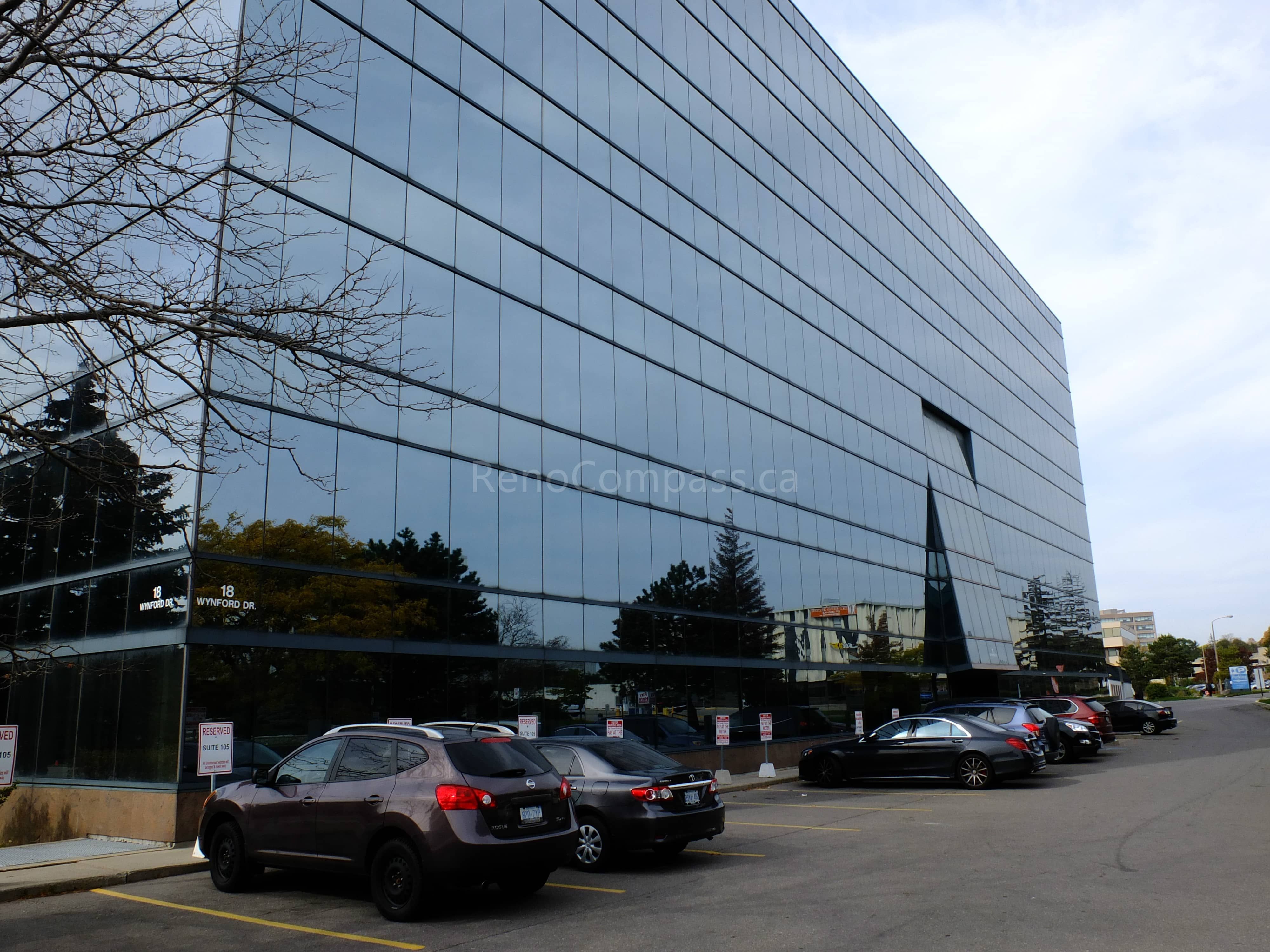 Exterior view of a modern glass office building in North York, Toronto, renovated as part of a commercial office renovation project. This project highlights a clean architectural façade, professional business environment, and strategic office location, completed by a trusted Toronto renovation company specializing in commercial and office renovations.