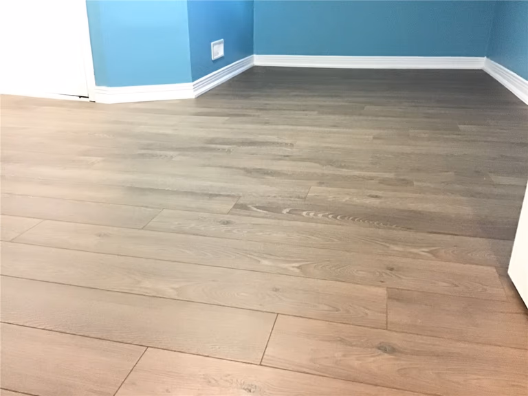 A clean, contemporary interior update in Markham. Our team handled the seamless wood floor installation and trim work to create a bright, inviting living space.