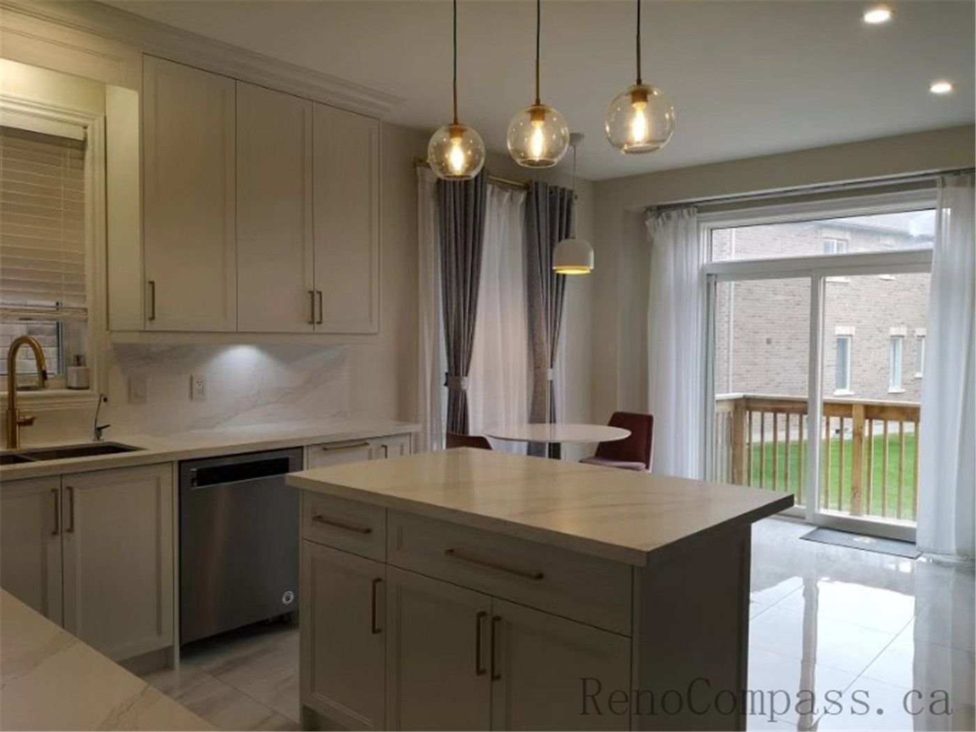This Aurora kitchen renovation showcases a bright open-concept design featuring custom white shaker cabinets, quartz countertops, and a functional center island. Elegant pendant lighting, marble-style flooring, and brushed gold fixtures add warmth and sophistication to the modern space. Completed by a professional Toronto renovation company focused on quality craftsmanship, efficient layout planning, and timeless interior design.