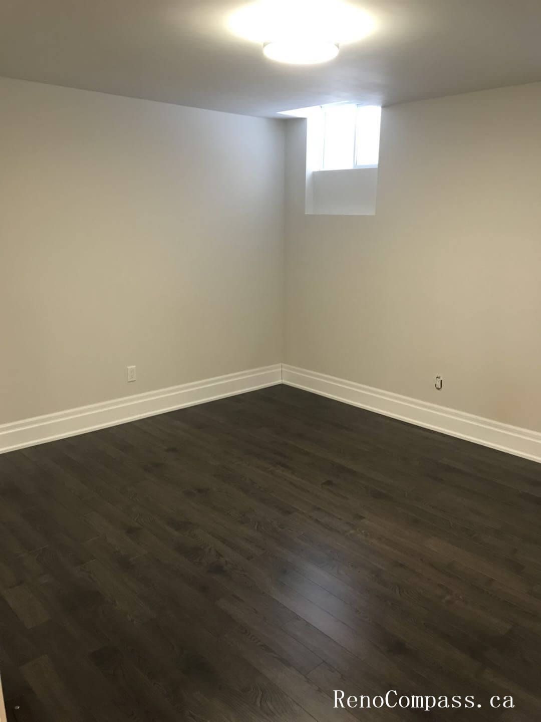 Finished basement renovation in Richmond Hill showcasing a newly completed basement bedroom with modern hardwood flooring, upgraded lighting, and fresh neutral wall finishes. This basement upgrade improves living space functionality, comfort, and property value with clean design and quality craftsmanship.