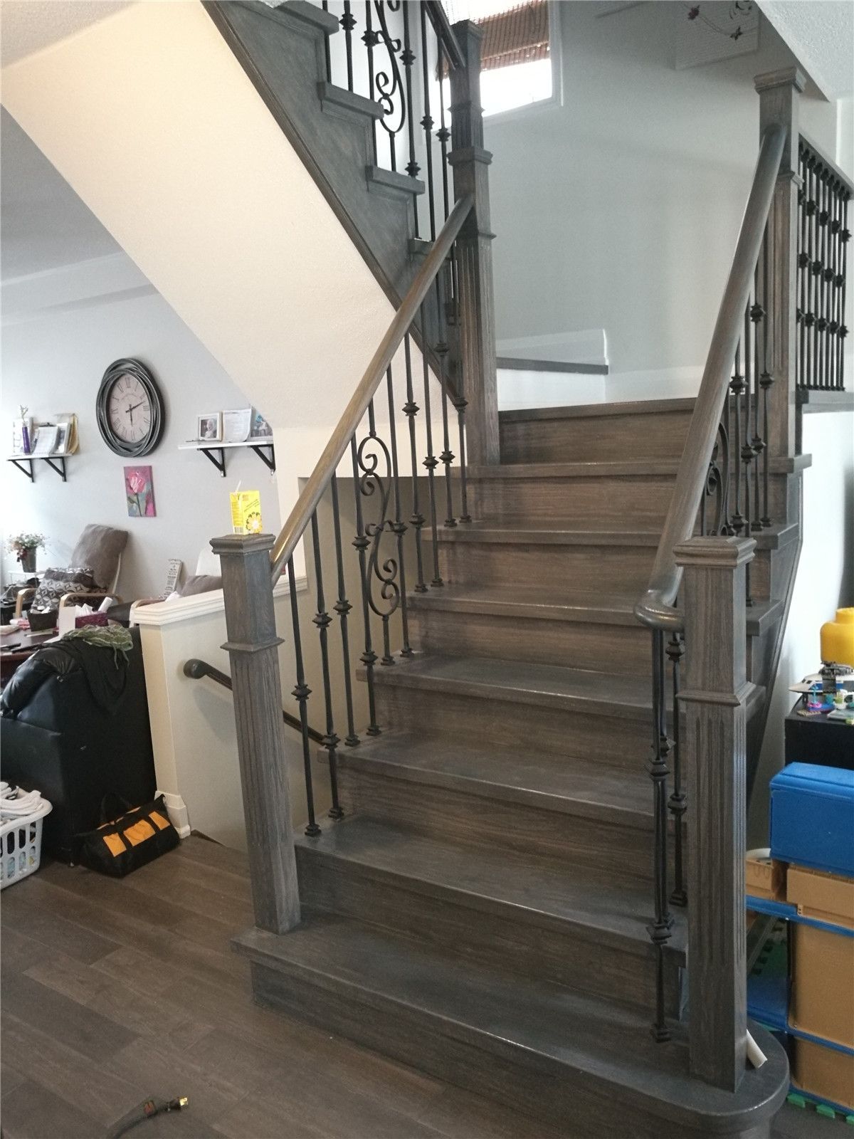 Interior renovation project in Richmond Hill featuring a fully upgraded wooden staircase with custom iron balusters, matching handrails, and coordinated flooring installation. This Toronto renovation company focused on improving safety, flow, and visual continuity between floors while maintaining a clean and timeless interior style.
