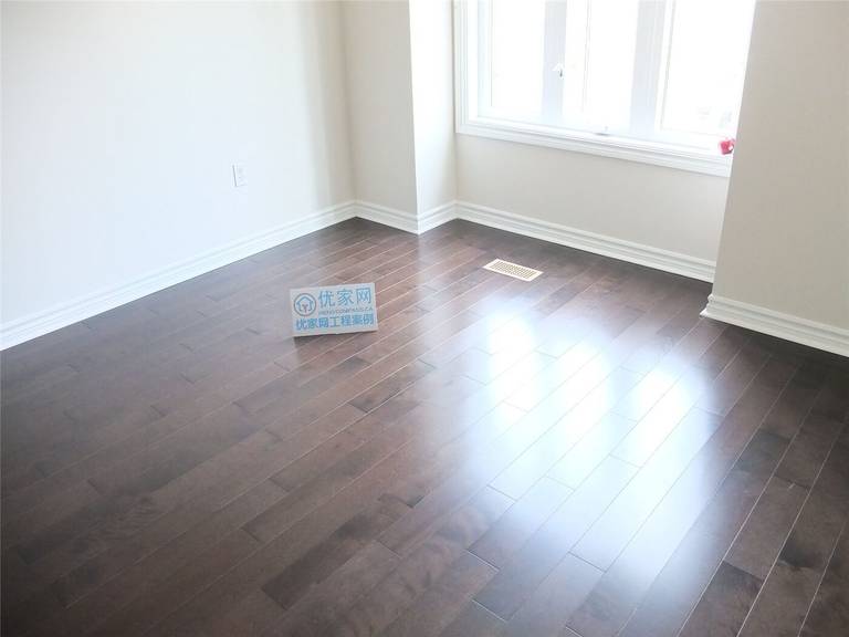 Finished dark hardwood flooring installation in a Toronto home renovation project, showing clean floor alignment, modern baseboards, and professional interior flooring upgrade by a Toronto renovation company.
