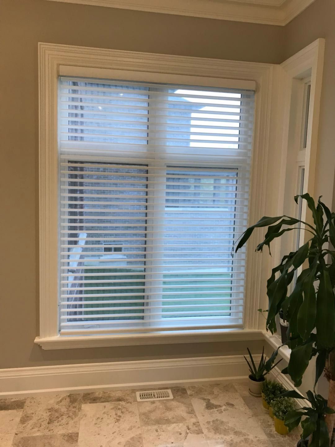 Custom zebra blinds installation in Toronto dining room by professional Toronto renovation company Reno Compass Inc. Featuring dual-layer light filtering shades, clean white window trim, modern chandelier lighting, and elegant wall panel detailing. This window treatment upgrade enhances privacy, natural light control, and interior aesthetics with a sleek and contemporary finish.