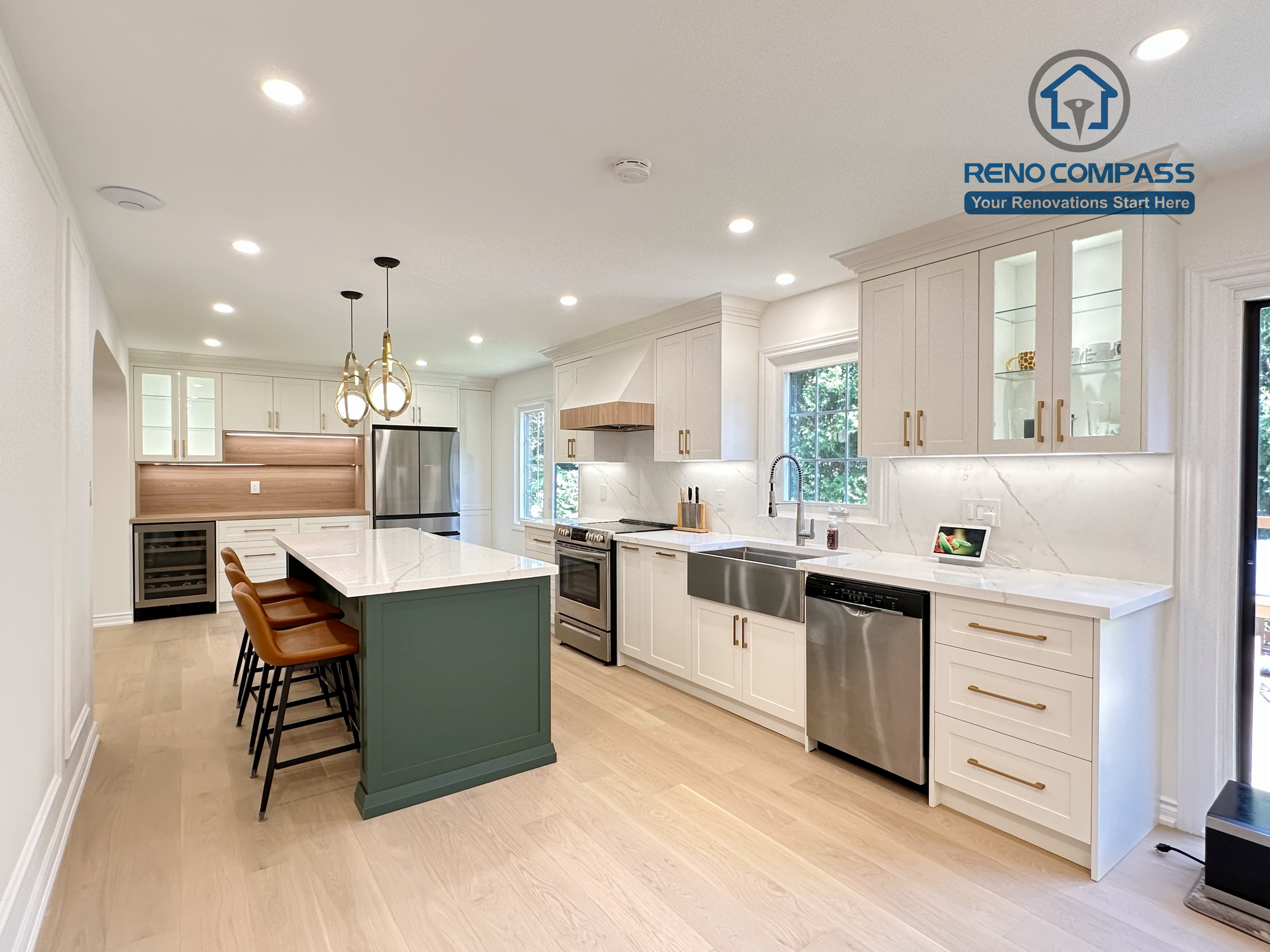 This Markham kitchen renovation highlights a spacious central island with seating, paired with a well-organized cooking area featuring quartz countertops, custom cabinetry, and stainless steel appliances. Pendant lighting and recessed ceiling lights provide balanced illumination, while wide-plank hardwood flooring enhances continuity throughout the space. Completed by a professional Toronto renovation company, Reno Compass Inc., the kitchen is designed for efficiency, comfort, and everyday use.
