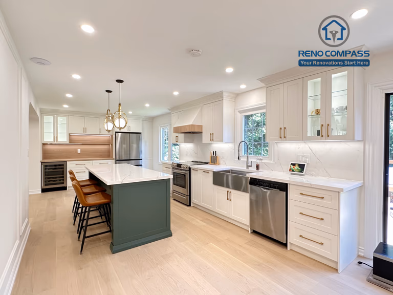 This Markham kitchen renovation highlights a spacious central island with seating, paired with a well-organized cooking area featuring quartz countertops, custom cabinetry, and stainless steel appliances. Pendant lighting and recessed ceiling lights provide balanced illumination, while wide-plank hardwood flooring enhances continuity throughout the space. Completed by a professional Toronto renovation company, Reno Compass Inc., the kitchen is designed for efficiency, comfort, and everyday use.