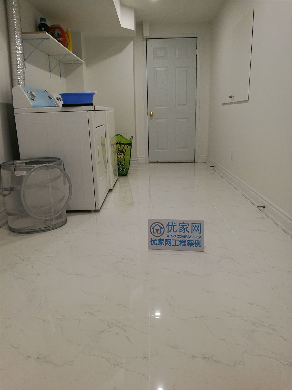 This image highlights a clean and functional laundry and utility area completed during a Vaughan basement renovation project. Designed for practicality and durability, the space features easy-maintenance floor tiles, bright lighting, and a well-organized layout that accommodates washer, dryer, and storage shelving. The open floor area allows for comfortable movement while maintaining a neat and efficient workflow.

Careful finishing around the ceiling bulkhead, walls, and trim ensures a polished and cohesive appearance that integrates seamlessly with the rest of the finished basement. Completed by an experienced Toronto Renovation Company, this basement laundry upgrade improves daily convenience while adding long-term usability and value to the home.