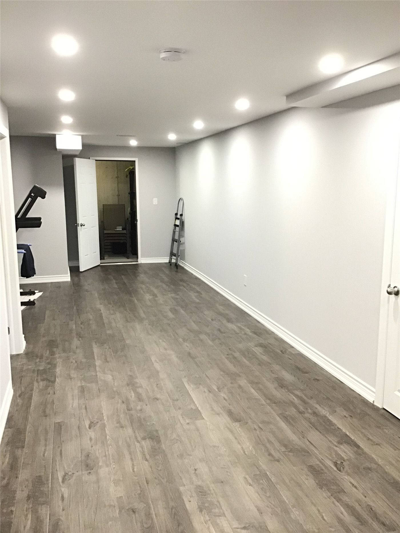 Aurora basement renovation showcasing a spacious open-concept layout with recessed pot lighting, modern vinyl plank flooring, and smooth neutral wall finishes. The clean design maximizes usable space for a home gym, entertainment area, or multi-purpose living room. Completed by a reliable Toronto renovation company focused on quality workmanship and long-term durability.