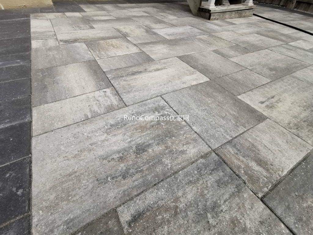 Close-up view of the interlocking patio surface in Vaughan, showcasing the natural stone texture, multi-tone grey pattern, and clean installation. This Reno Compass project delivers lasting durability and a sophisticated modern look.