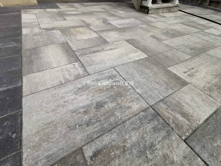 Close-up view of the interlocking patio surface in Vaughan, showcasing the natural stone texture, multi-tone grey pattern, and clean installation. This Reno Compass project delivers lasting durability and a sophisticated modern look.
