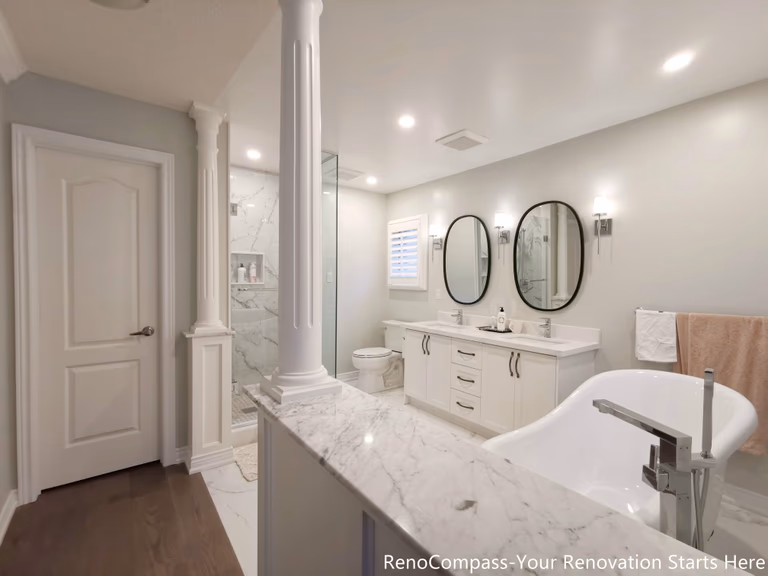 This Oakville interior renovation focused on elevating both comfort and material quality, with particular attention given to the bathroom and core living spaces. The project combines refined finishes with a practical layout, creating a home environment that feels both luxurious and suitable for long-term everyday use.

The bathroom renovation features elegant marble flooring, which adds visual depth while enhancing durability and ease of maintenance. A custom double vanity provides ample storage and shared functionality, making the space ideal for daily routines without congestion. An independent freestanding bathtub serves as a focal point of the room, offering a spa-inspired experience while maintaining a clean, balanced layout.

Throughout the interior, neutral tones and carefully selected materials create a cohesive visual flow. Clean lines, precise detailing, and thoughtful spacing ensure the design feels open rather than overdecorated. Lighting and fixtures were chosen to complement the stone finishes, enhancing both warmth and clarity across the space.

This Oakville interior renovation reflects a design approach that prioritizes quality materials, functional planning, and timeless aesthetics. Executed by Reno Compass, the project delivers a refined interior that balances everyday practicality with a sense of understated luxury.