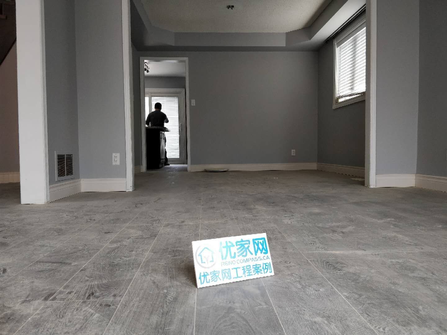 This living area renovation in Ajax features modern grey-tone flooring, clean wall finishes, and a minimalist interior layout. The updated space highlights improved durability and a contemporary aesthetic, creating a bright and open environment. As part of a full house renovation project, the flooring and wall upgrades enhance both comfort and long-term value for the homeowner.