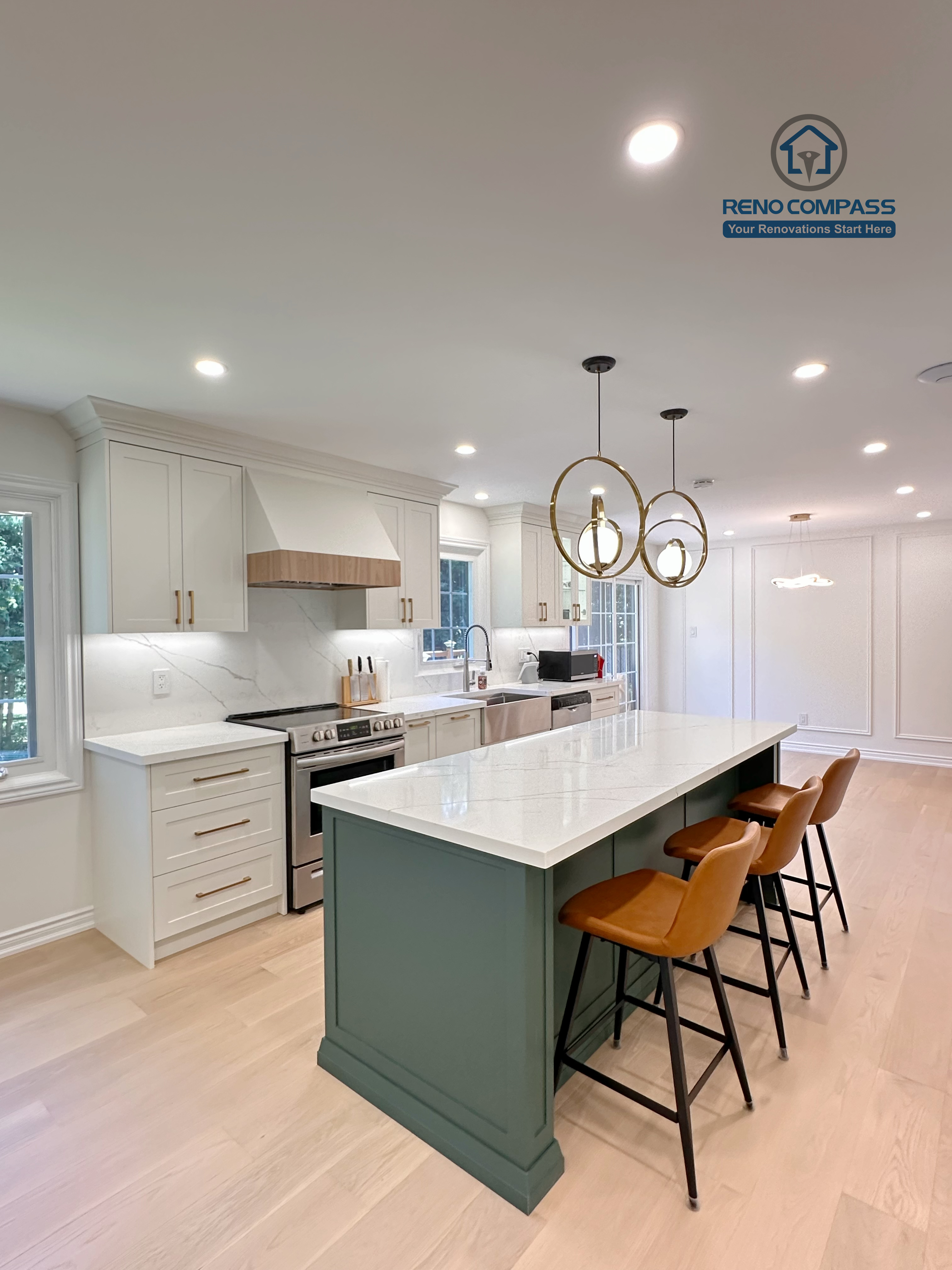 This Markham kitchen renovation highlights a spacious central island with seating, paired with a well-organized cooking area featuring quartz countertops, custom cabinetry, and stainless steel appliances. Pendant lighting and recessed ceiling lights provide balanced illumination, while wide-plank hardwood flooring enhances continuity throughout the space. Completed by a professional Toronto renovation company, Reno Compass Inc., the kitchen is designed for efficiency, comfort, and everyday use.
