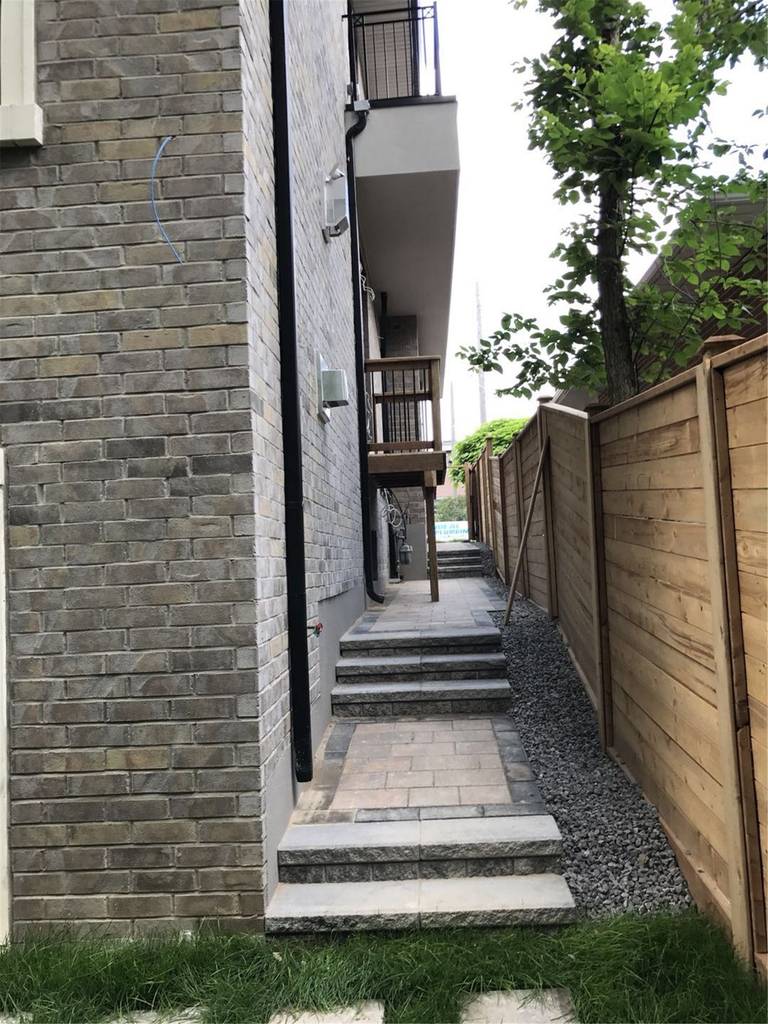 This Markham landscaping renovation includes a professionally installed interlocking stone walkway with step transitions, decorative gravel drainage, and a natural wood privacy fence. The project improves accessibility along the side yard while creating a clean and organized outdoor pathway. Completed by a trusted Toronto Renovation Company, the design combines durability, functionality, and modern landscaping aesthetics for long-term outdoor performance.