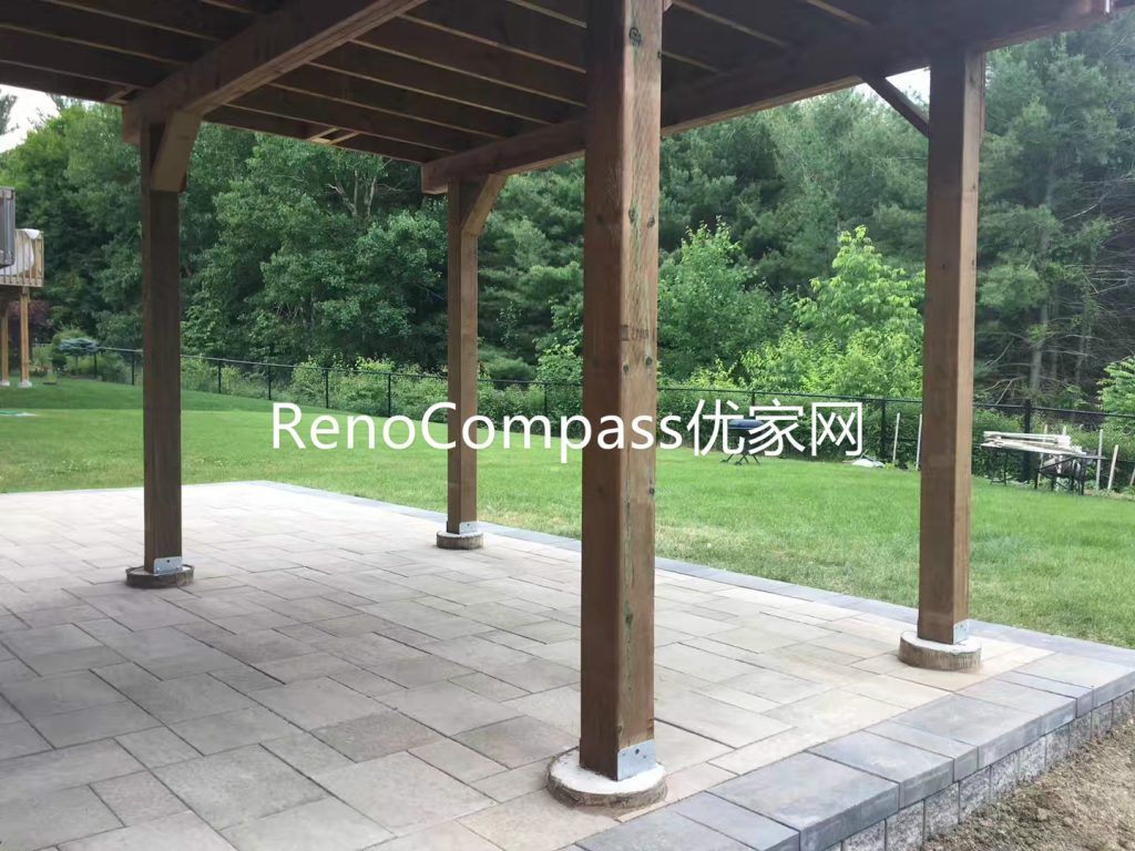 Covered backyard patio renovation in Richmond Hill featuring durable interlocking stone flooring and solid wood deck structure support. This outdoor living space provides weather protection, enhanced functionality, and a comfortable area for relaxation and gatherings while improving overall backyard value and usability.