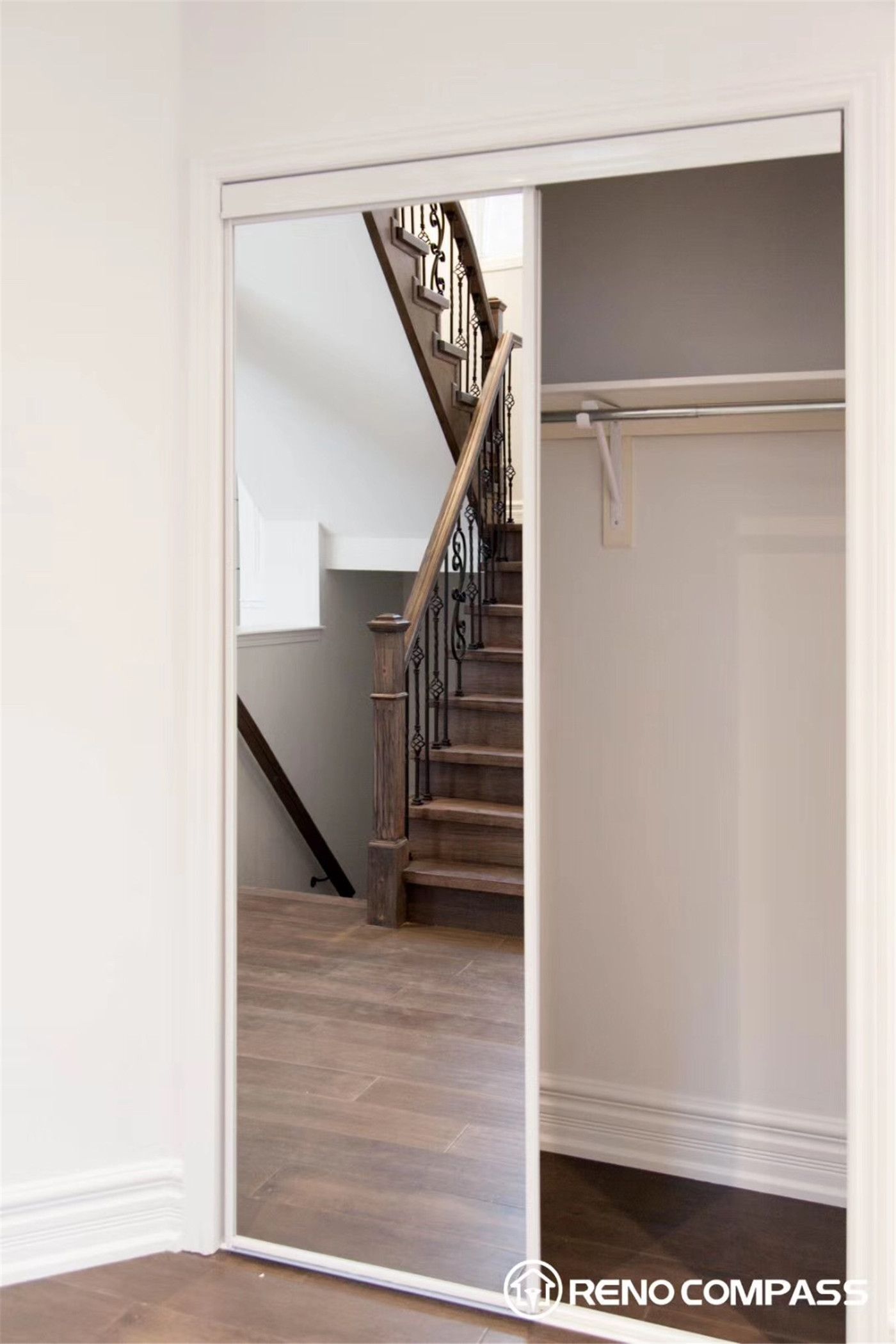 This Markham interior renovation highlights a beautifully crafted staircase featuring rich solid wood steps paired with elegant wrought iron balusters. The combination of warm wood tones and intricate metal detailing creates a timeless yet modern look, enhancing both the functionality and visual appeal of the home.