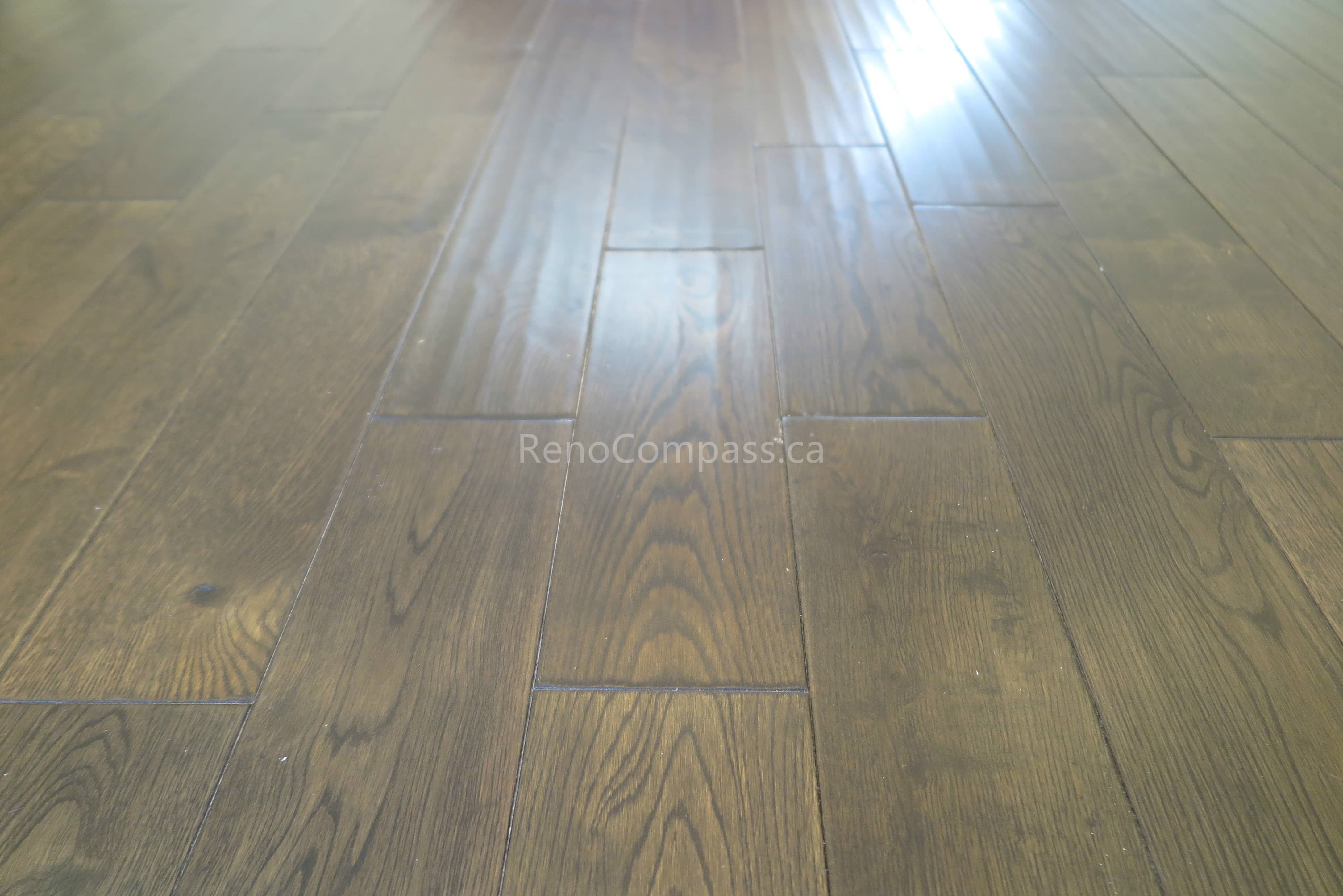 This North York flooring project highlights premium dark hardwood floor installation with a smooth finish and natural wood grain texture. The carefully aligned planks create a seamless and modern look that enhances both durability and visual appeal. Completed by Reno Compass Inc., this flooring upgrade adds warmth, elegance, and long-lasting performance to the home’s interior living space.