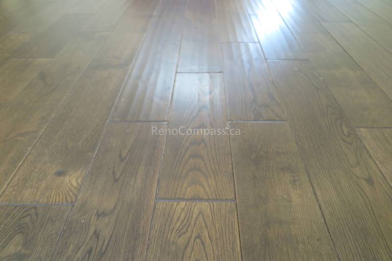 This North York flooring project highlights premium dark hardwood floor installation with a smooth finish and natural wood grain texture. The carefully aligned planks create a seamless and modern look that enhances both durability and visual appeal. Completed by Reno Compass Inc., this flooring upgrade adds warmth, elegance, and long-lasting performance to the home’s interior living space.