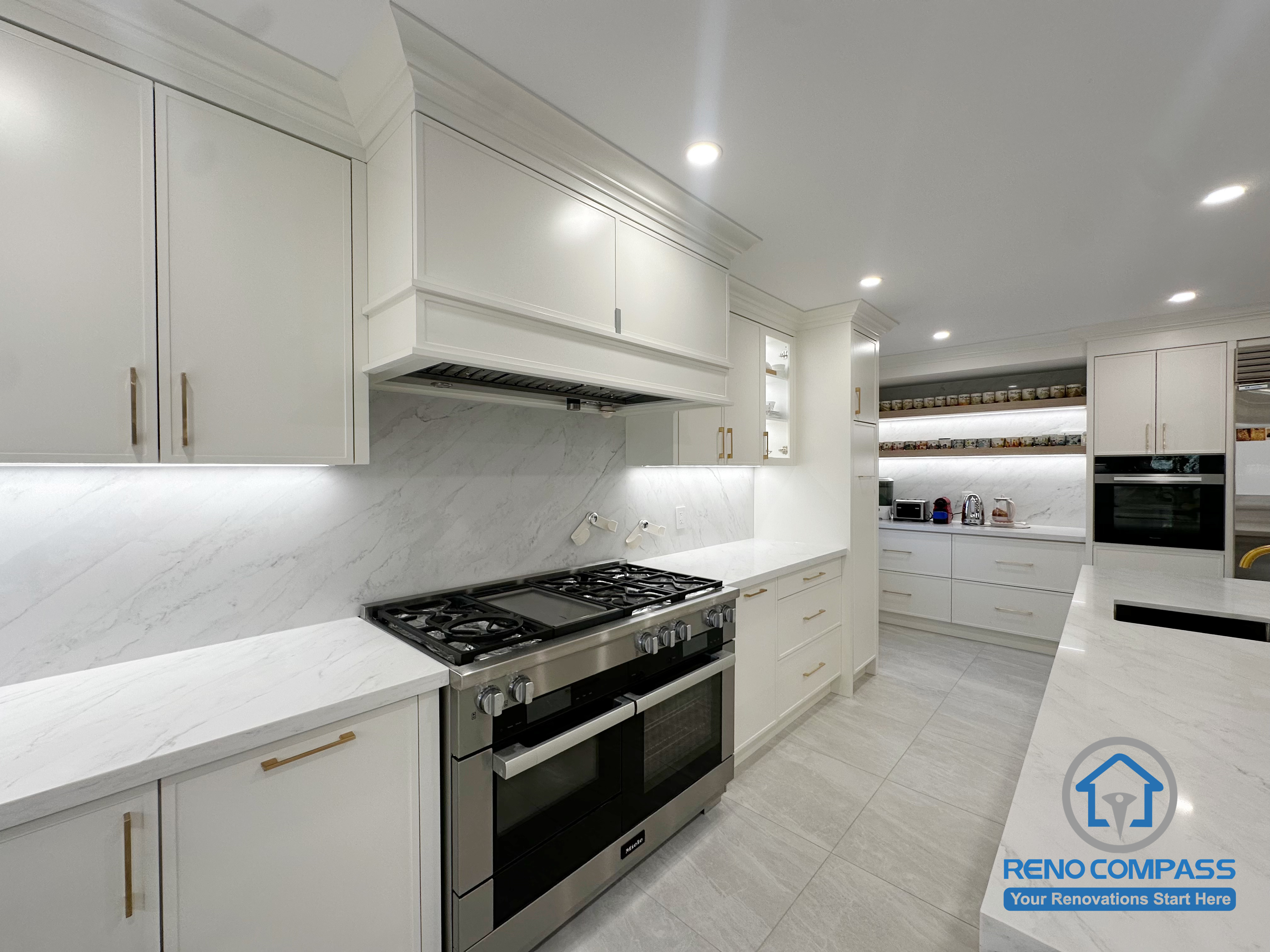This kitchen renovation showcases custom cabinetry with clean proportions and a seamless quartz backsplash that enhances visual continuity across the space. Integrated lighting and carefully aligned millwork details contribute to a refined, cohesive look, while the layout prioritizes clear circulation and long-term usability. The result is a well-balanced kitchen design focused on craftsmanship, functionality, and overall finish quality.