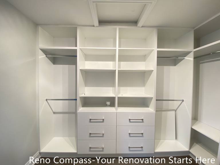 Custom walk-in closet featured in an Oakville interior renovation, showcasing built-in shelving, hanging rods, and integrated drawer storage for optimal organization. The clean white cabinetry and functional layout provide a modern storage solution designed and completed by a professional Toronto renovation company.
