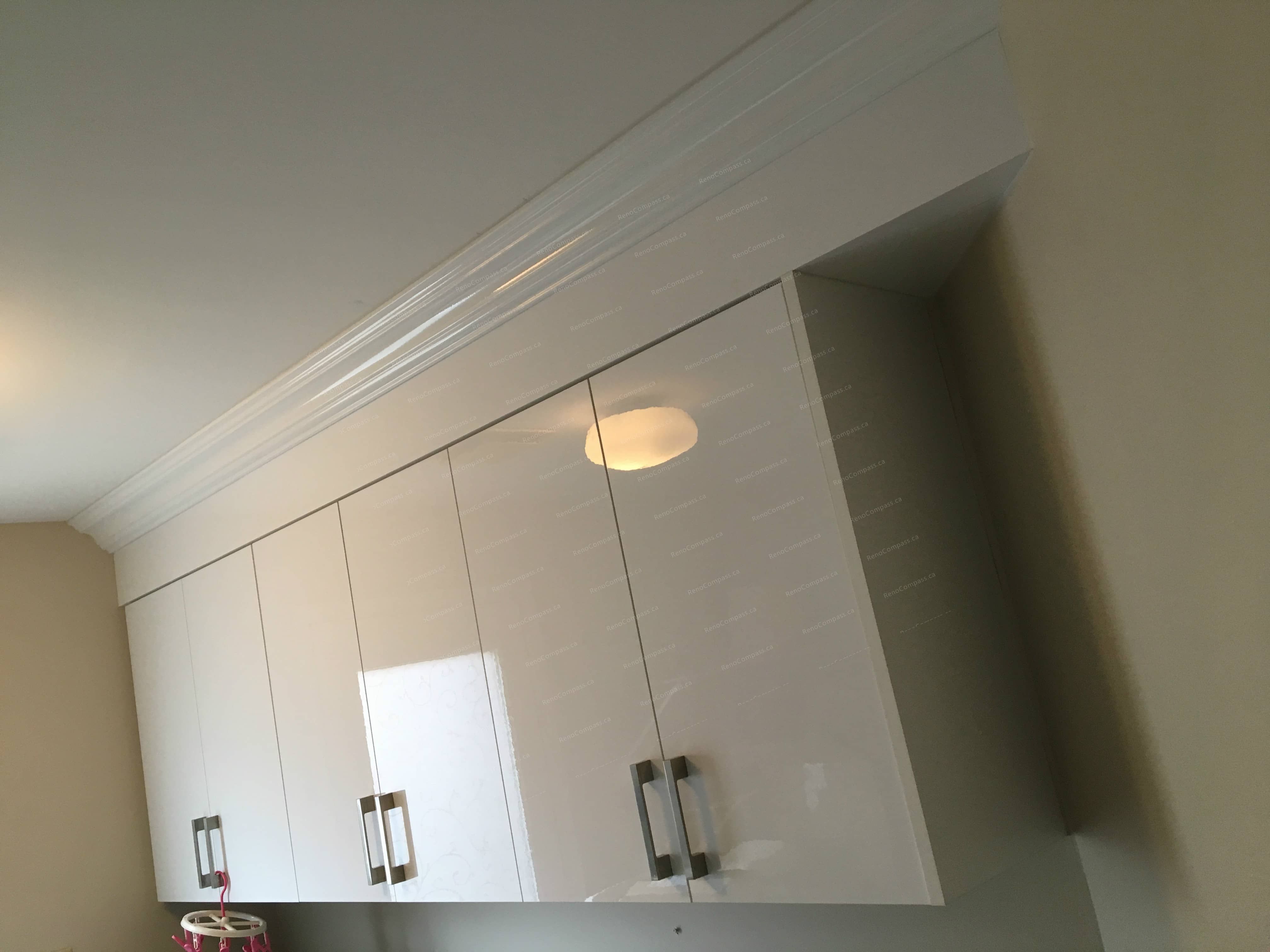 This Oakville interior renovation showcases a clean and functional laundry room upgrade with custom-built white cabinetry, durable stone-style countertops, and optimized storage solutions. The modern cabinet design provides ample space for organization while enhancing the overall brightness and efficiency of the room. Thoughtful layout improvements and quality materials create a practical yet stylish laundry space, reflecting professional craftsmanship and modern interior renovation standards for Oakville homes.