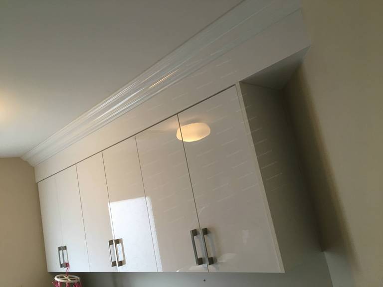 This Oakville interior renovation showcases a clean and functional laundry room upgrade with custom-built white cabinetry, durable stone-style countertops, and optimized storage solutions. The modern cabinet design provides ample space for organization while enhancing the overall brightness and efficiency of the room. Thoughtful layout improvements and quality materials create a practical yet stylish laundry space, reflecting professional craftsmanship and modern interior renovation standards for Oakville homes.