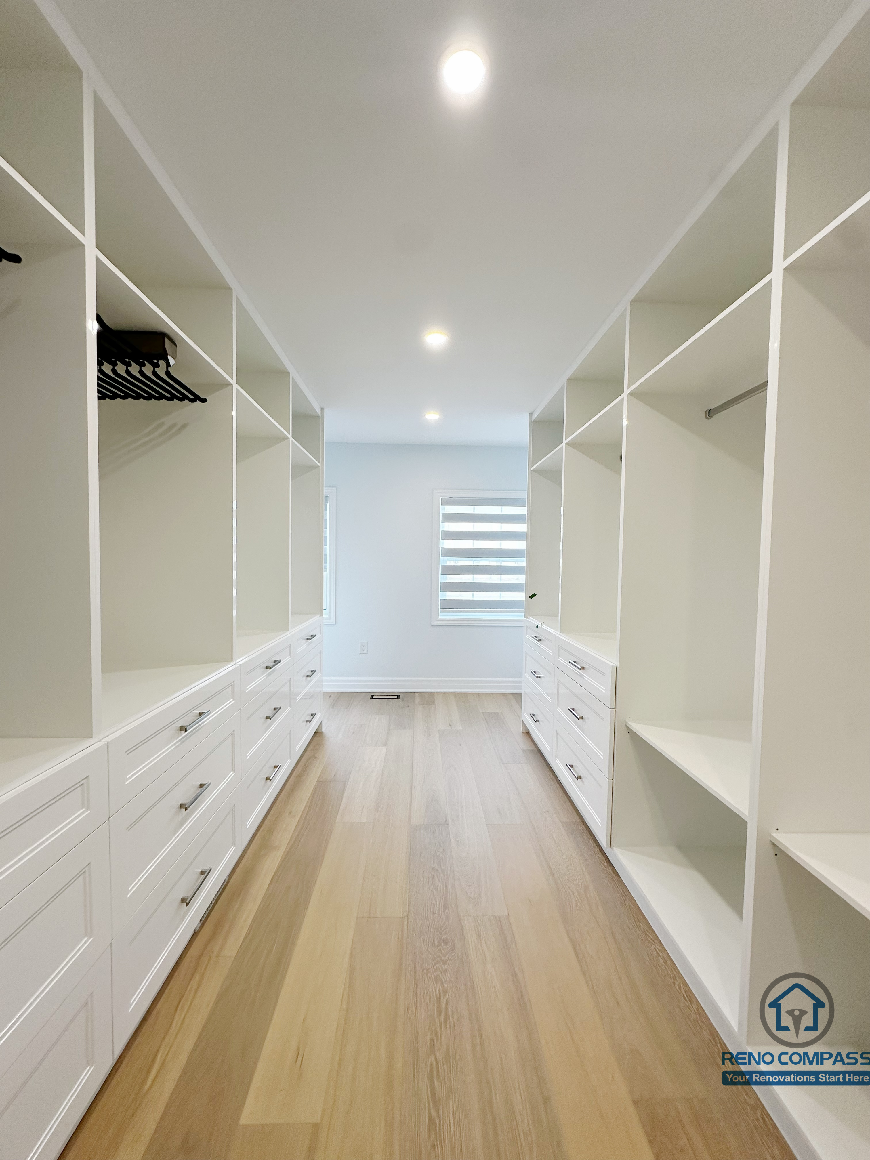 Spacious walk-in closet designed with custom built