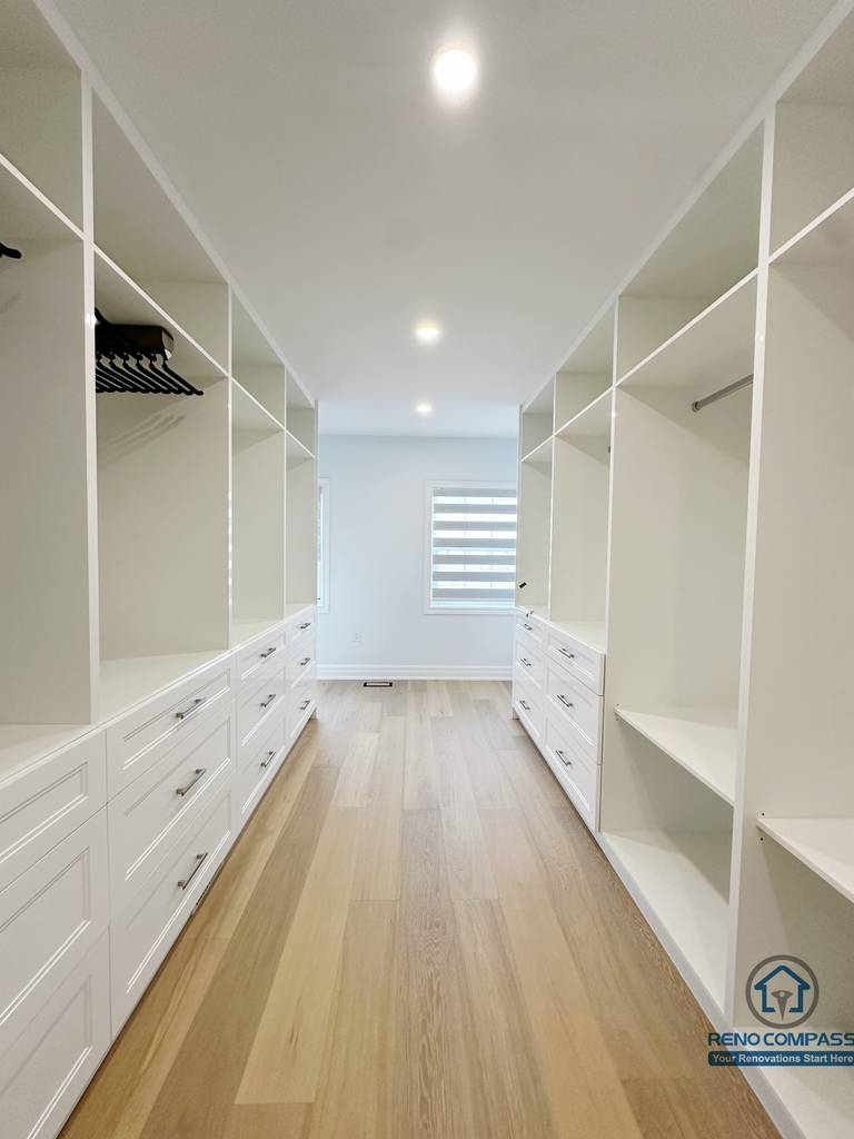 Spacious walk-in closet designed with custom built