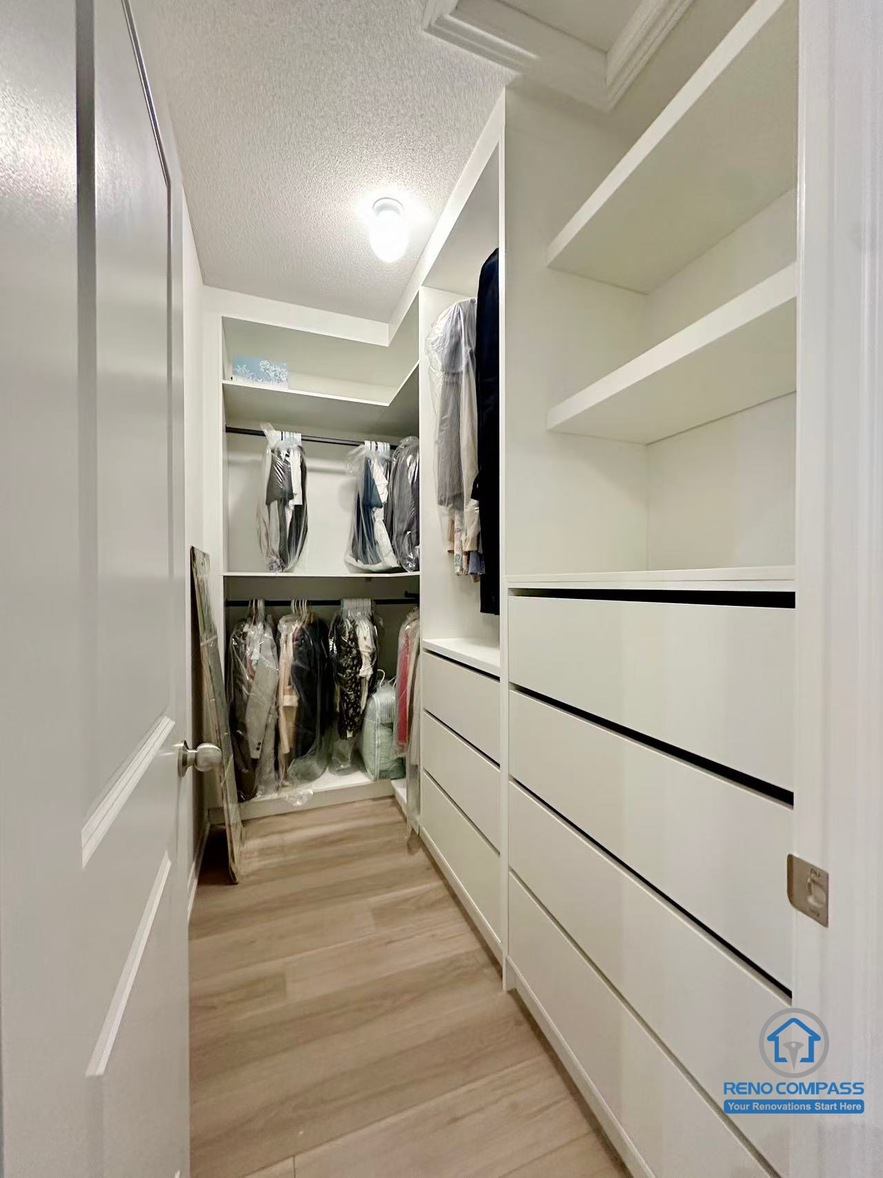 This Stouffville interior renovation features a custom walk-in closet with built-in shelving, drawers, and hanging storage designed for maximum organization and efficiency. Clean white cabinetry, wood-look flooring, and integrated lighting create a bright and functional dressing space. Completed by a professional Toronto renovation company, Reno Compass Inc., this custom storage solution reflects thoughtful interior planning and high-quality craftsmanship.