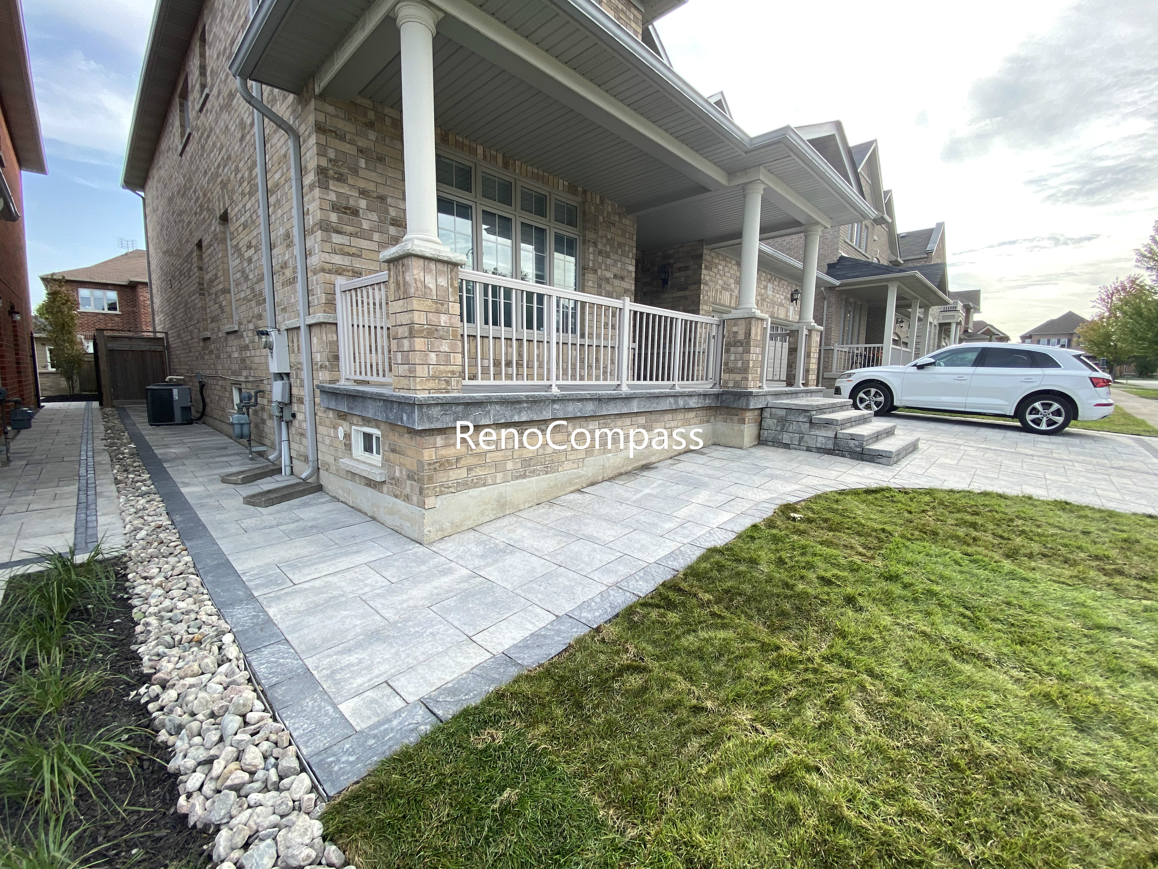 This Aurora front yard interlocking project highlights a seamless connection between the front porch, side walkway, and driveway area. Large-format concrete pavers are installed with clean alignment to ensure durability, proper drainage, and long-term performance. The neutral stone finish complements the home’s brick exterior while creating a functional and visually cohesive outdoor layout. This professionally designed interlock walkway enhances accessibility, curb appeal, and overall outdoor flow for residential properties in Aurora.