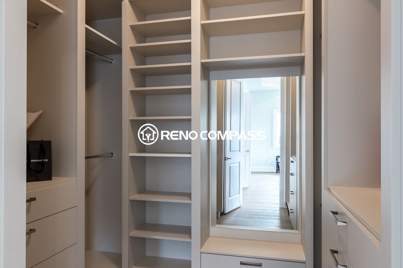 Custom walk-in closet renovation in Newmarket featuring built-in shelving, hanging space and storage drawers for improved organization. Completed by a professional Toronto renovation company, this design maximizes storage efficiency while maintaining a clean and modern look.