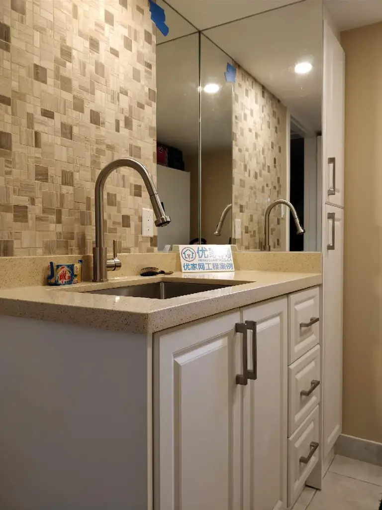 A professional basement transformation by Reno Compass in Scarborough. This project highlights modern space-saving solutions, including a custom wet bar and premium cabinetry installations.