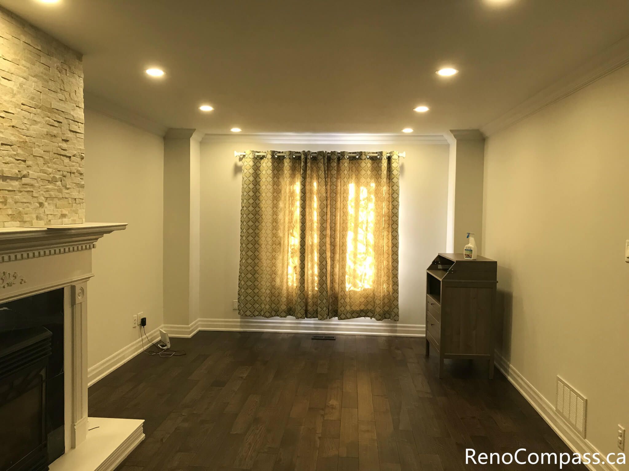 This Mississauga interior renovation highlights a bright bay window living space enhanced with custom curtain installation, detailed trim work, and rich hardwood flooring. The upgraded windows improve natural light control while adding warmth and elegance to the room. Completed by a trusted Toronto renovation company, Reno Compass Inc., this project showcases refined interior finishing and professional craftsmanship.
