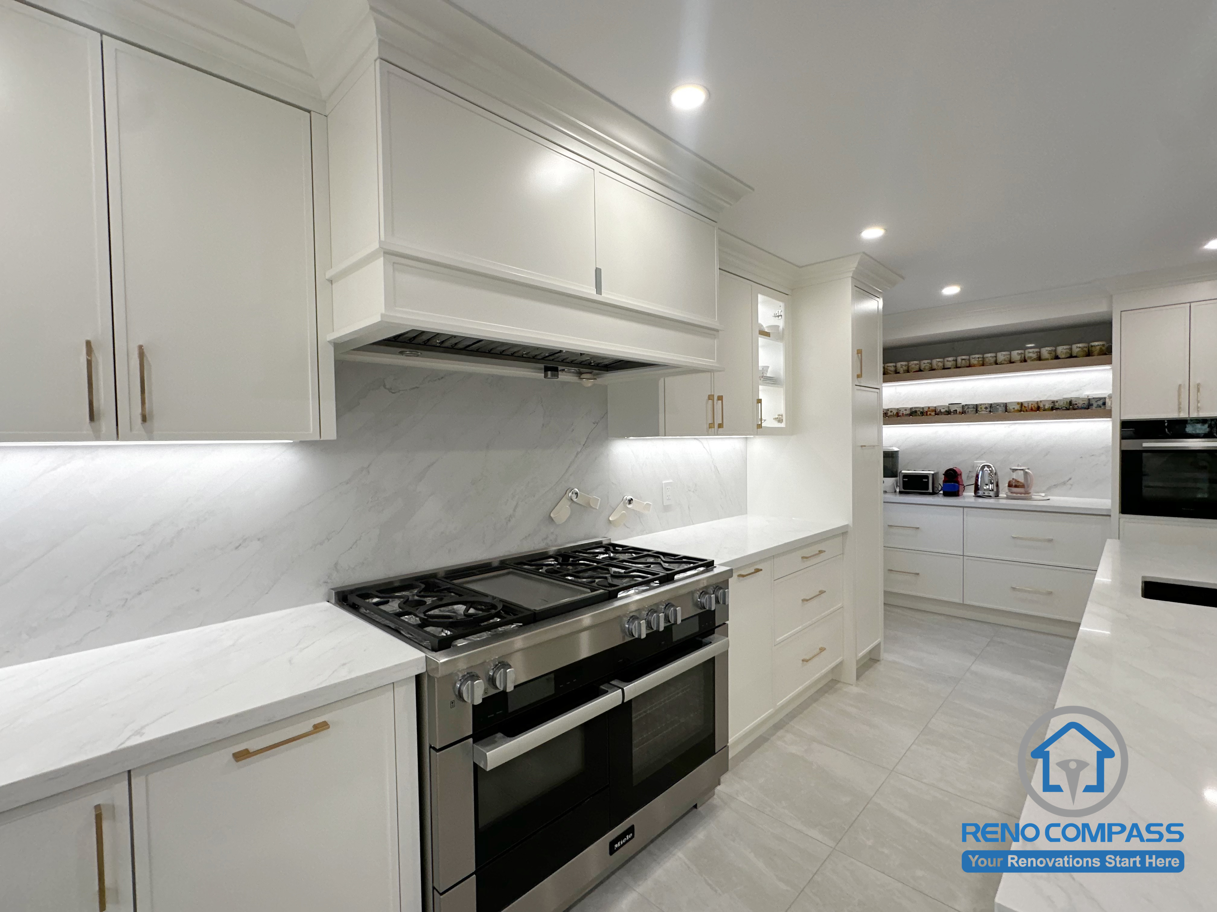 This kitchen renovation showcases custom cabinetry with clean proportions and a seamless quartz backsplash that enhances visual continuity across the space. Integrated lighting and carefully aligned millwork details contribute to a refined, cohesive look, while the layout prioritizes clear circulation and long-term usability. The result is a well-balanced kitchen design focused on craftsmanship, functionality, and overall finish quality.