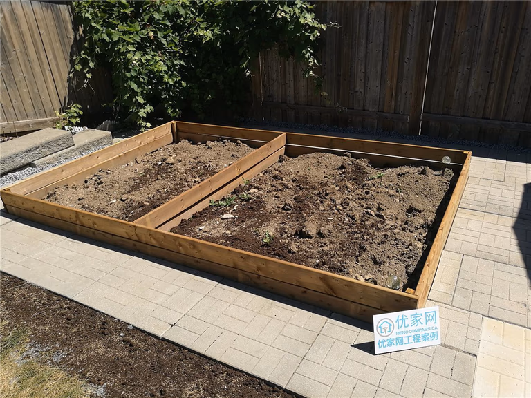 This Vaughan landscaping renovation features a custom-built wooden raised garden bed designed to add structure and functionality to the backyard. Framed with durable pressure-treated lumber and neatly positioned over a newly installed interlocking patio, the garden boxes create a defined planting area while maintaining a clean, organized layout. Completed by Reno Compass Inc., this project highlights precise carpentry, practical outdoor design, and a seamless integration between hardscape and softscape elements.