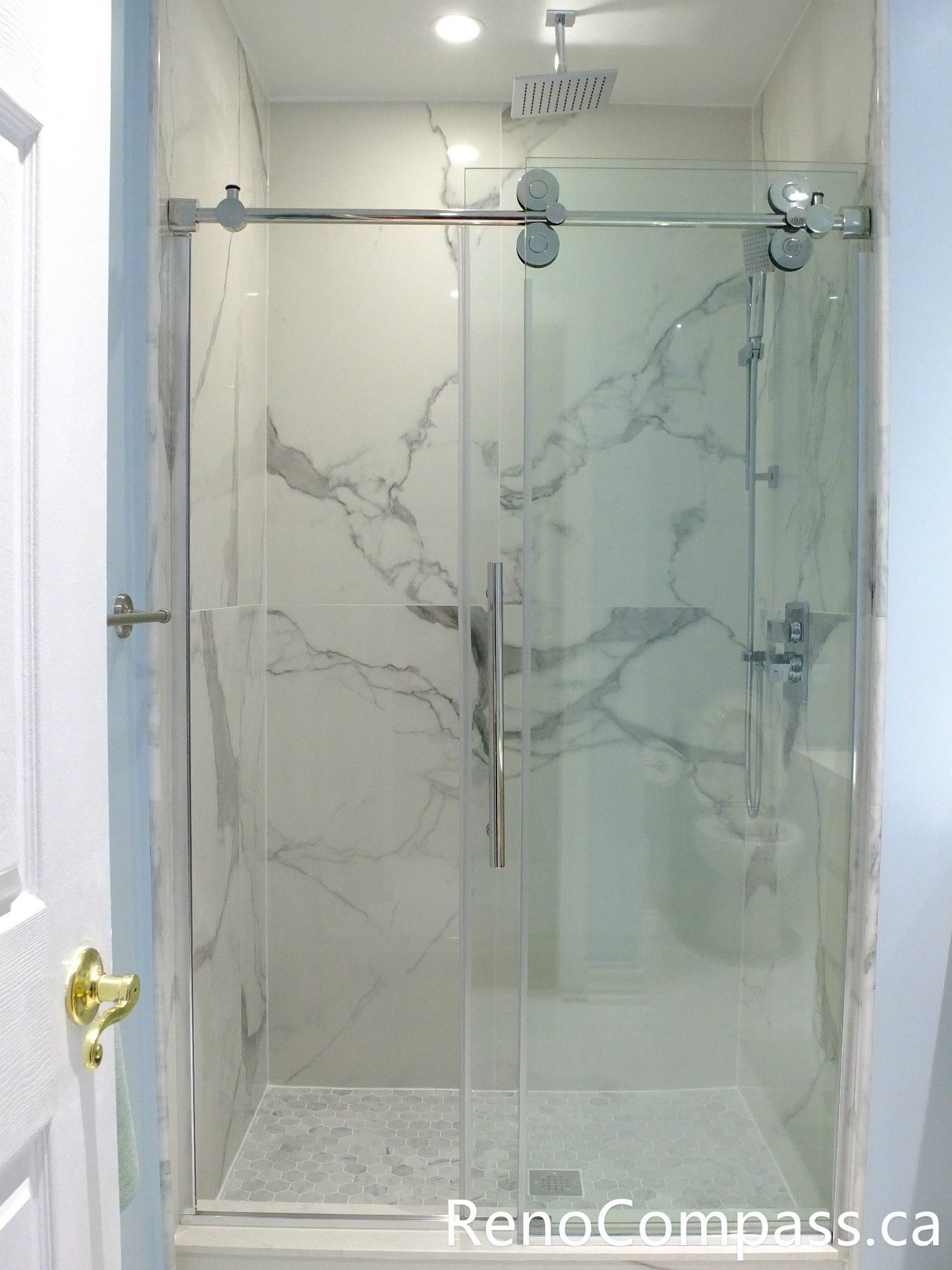 This Richmond Hill bathroom renovation features a sleek frameless glass shower enclosure, marble-look wall tiles, and a clean modern layout designed for comfort and durability. Completed by a professional Toronto renovation company, the space combines elegant finishes with practical functionality, creating a bright and contemporary bathroom upgrade for everyday living.
