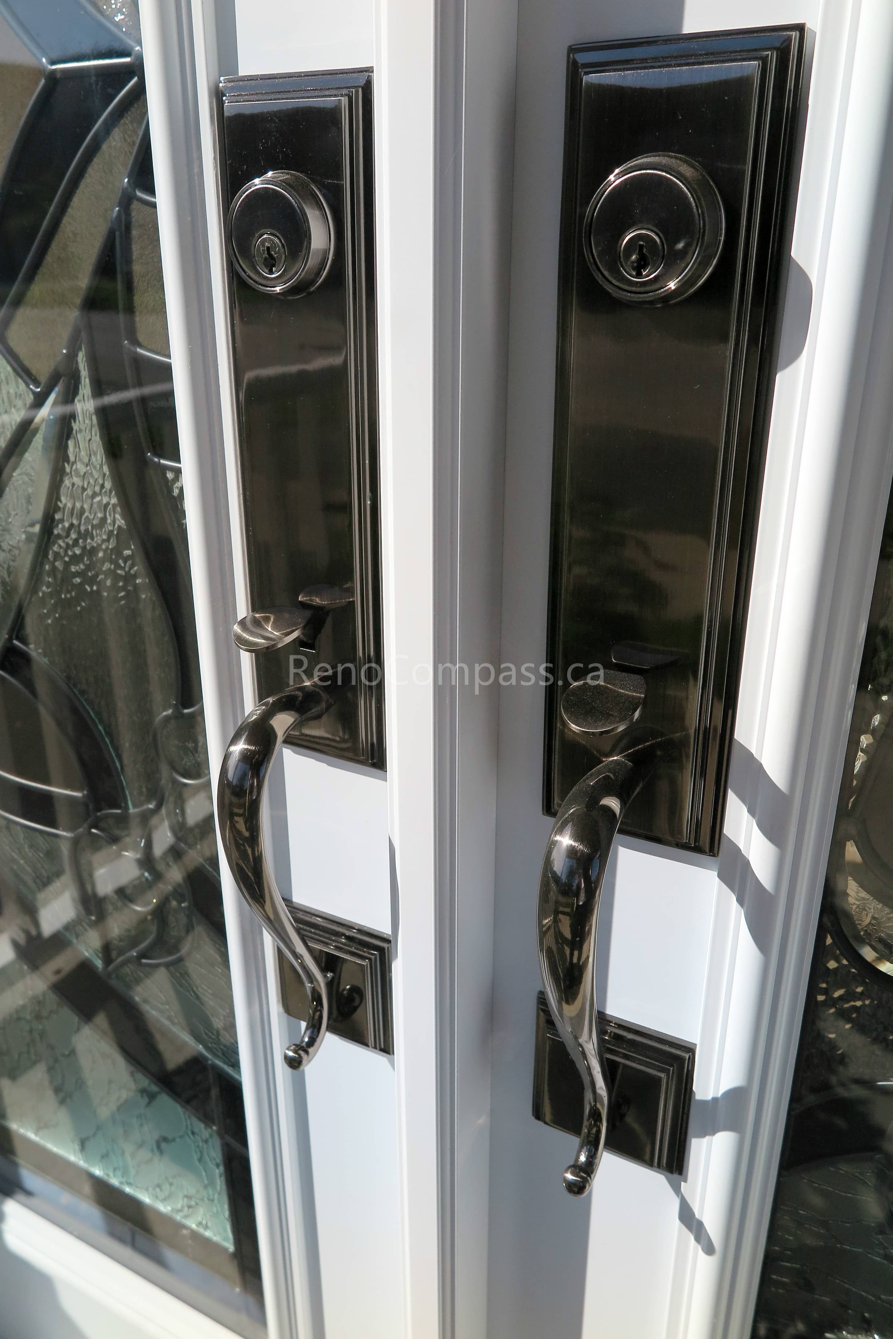 Close-up detail of newly installed double entry door hardware in a New market home, featuring modern black handles and secure locking systems paired with decorative privacy glass panels. Completed by a professional Toronto Renovation Company, this door upgrade enhances both security and visual appeal while adding a refined, high-end finish to the home’s main entrance.