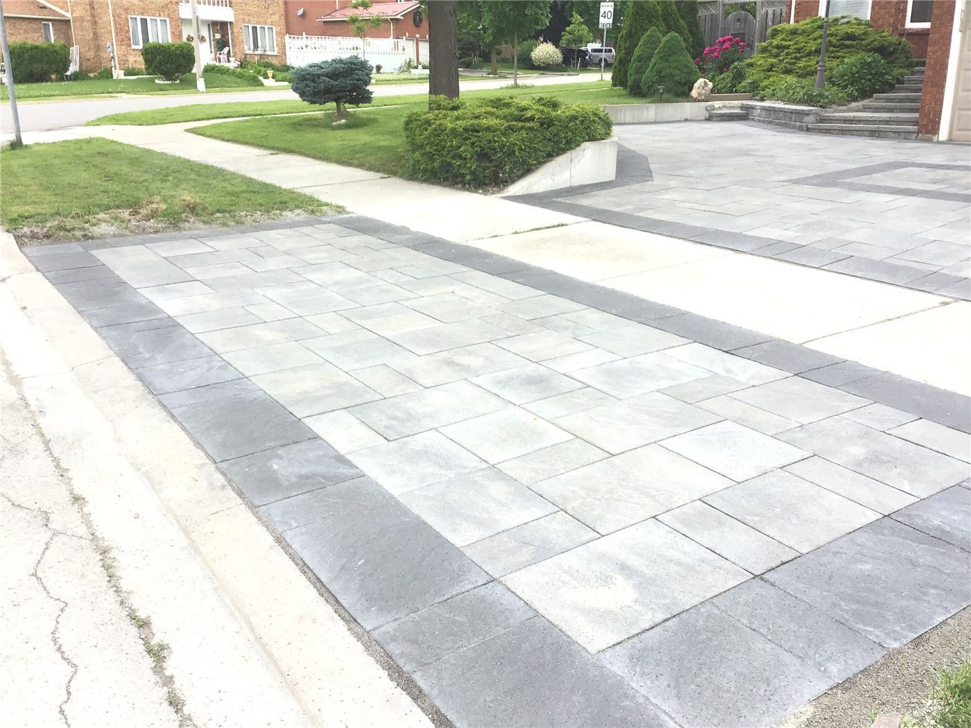 A newly upgraded front entrance with custom stone steps and interlocking porch design. This Mississauga landscaping project improves safety, functionality, and overall home appearance with durable materials and a clean, modern finish.