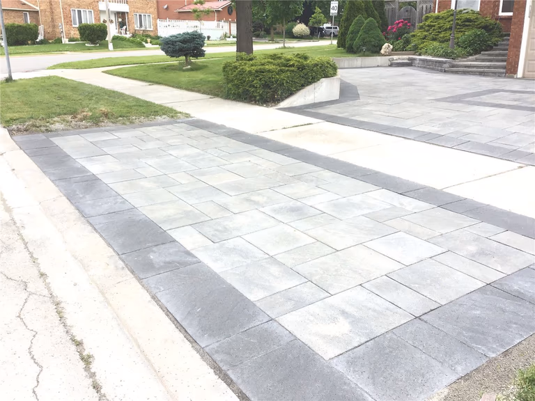 A newly upgraded front entrance with custom stone steps and interlocking porch design. This Mississauga landscaping project improves safety, functionality, and overall home appearance with durable materials and a clean, modern finish.