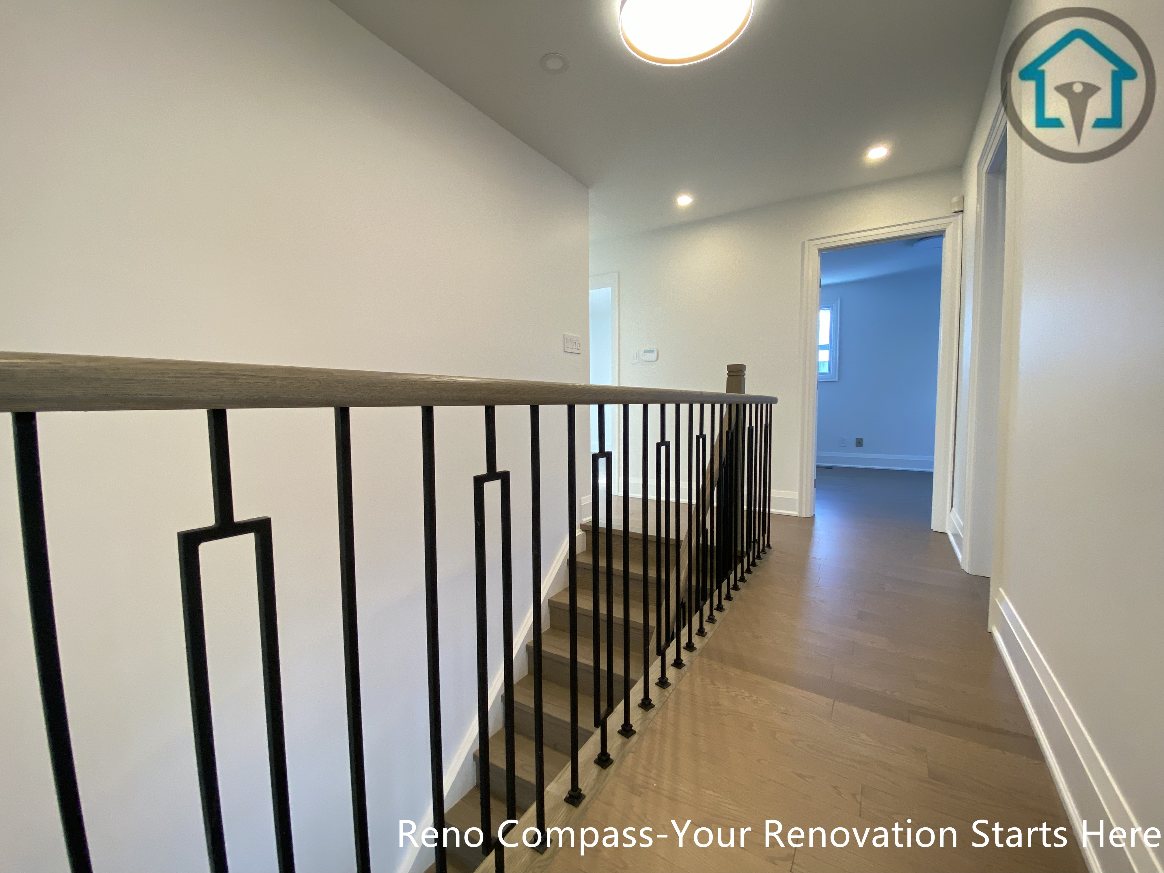 This image features a second-floor hallway renovation in Markham, completed by a Toronto Renovation Company, Reno Compass Inc. Light-toned hardwood flooring creates a clean and cohesive look, enhancing brightness and continuity throughout the upper level of the home.
